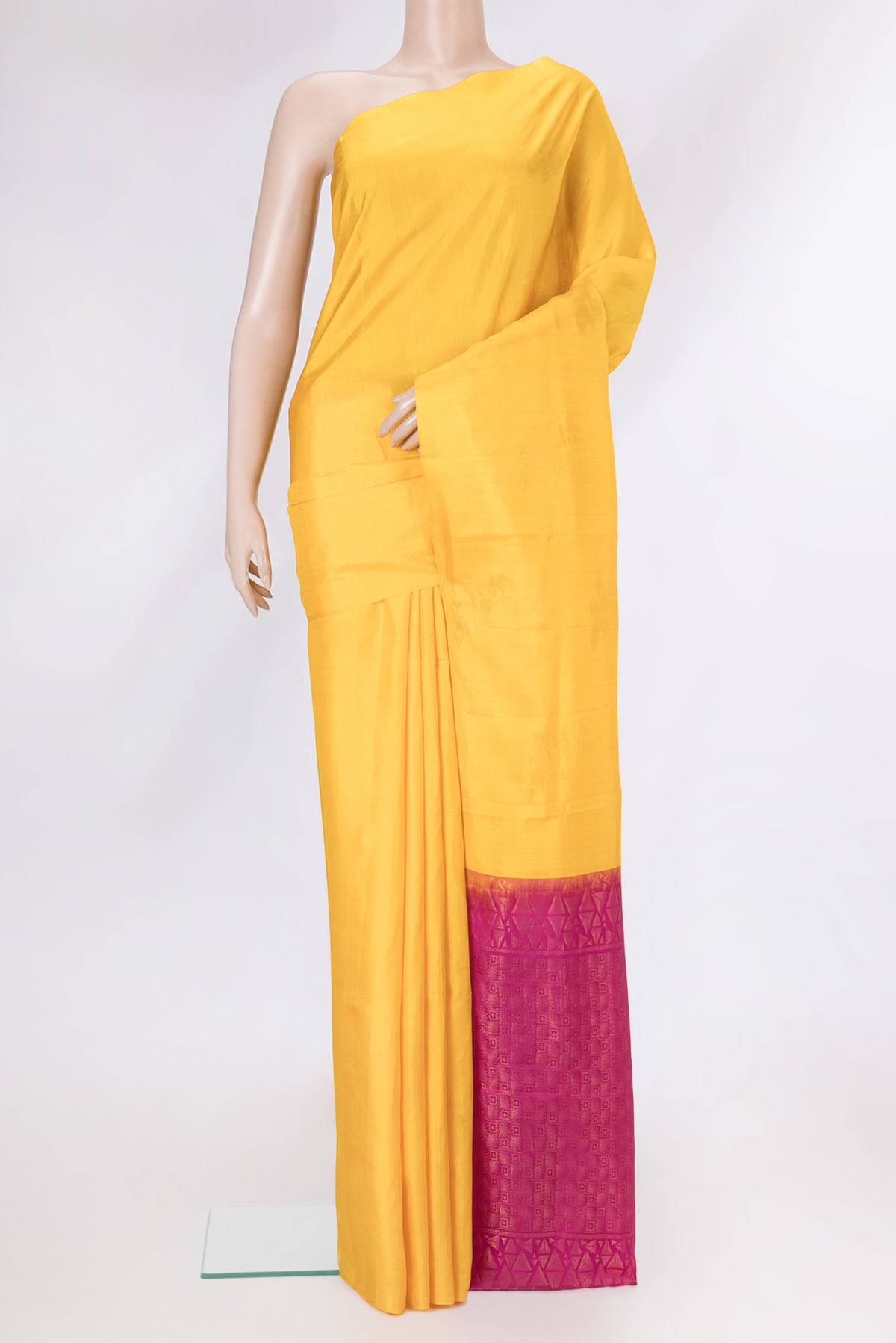 Yellow Soft Silk Saree with Stripes on the body and Without Border.  displayed on a mannequin