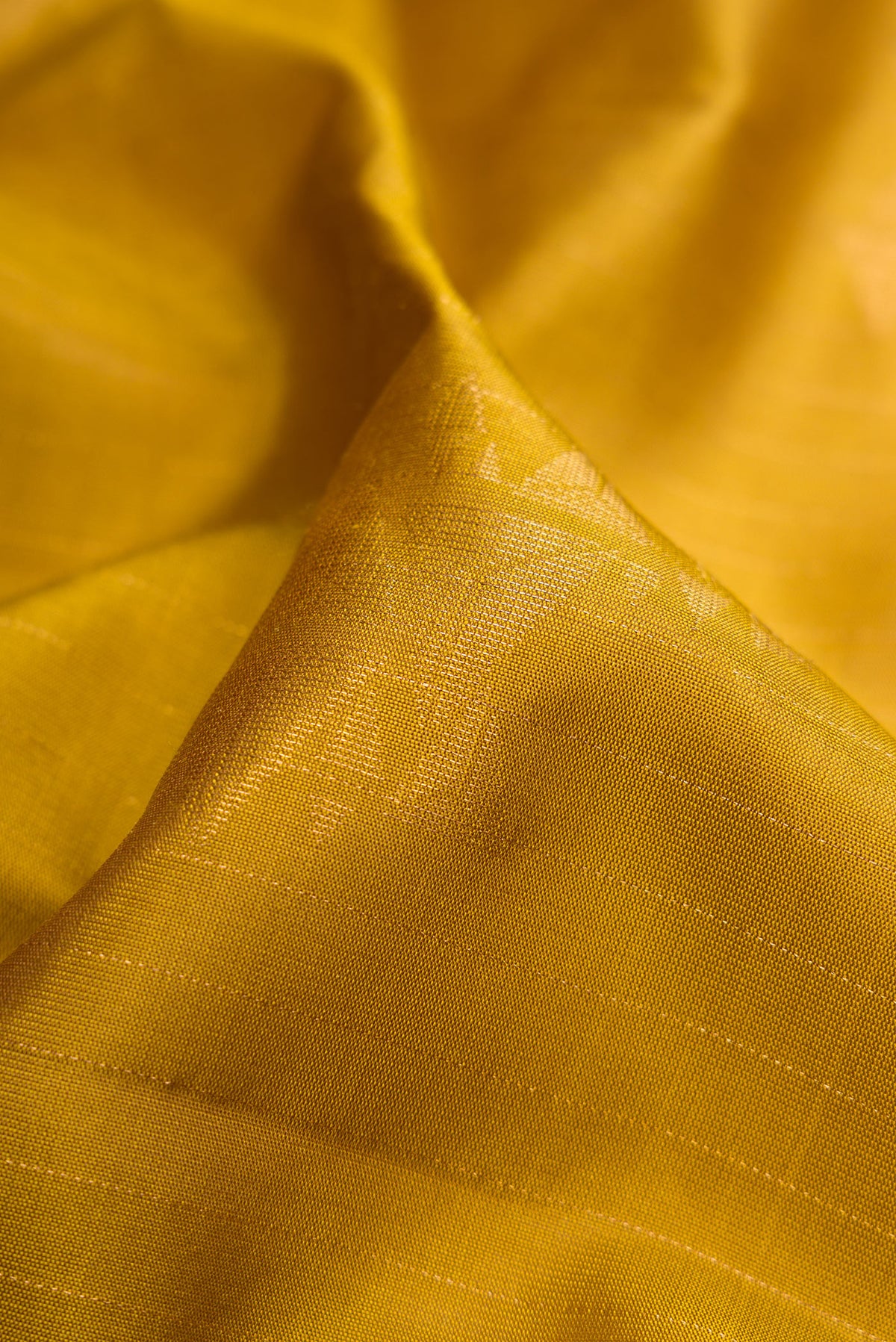 Close up of Mehandi Green Dual Tone Soft Silk Saree with Zari Butta on the body and Without Border.  displaying folds