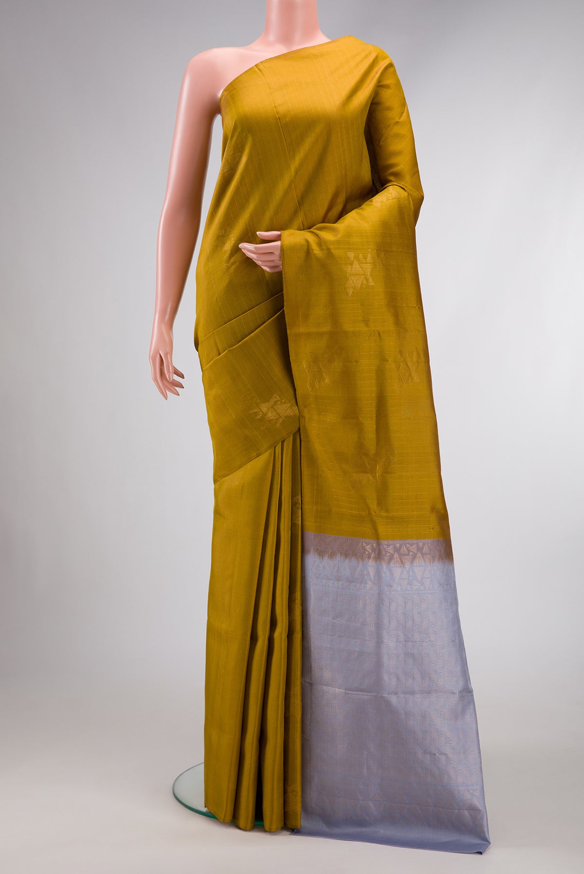 Mehandi Green Dual Tone Soft Silk Saree with Zari Butta on the body and Without Border.  displayed on a mannequin