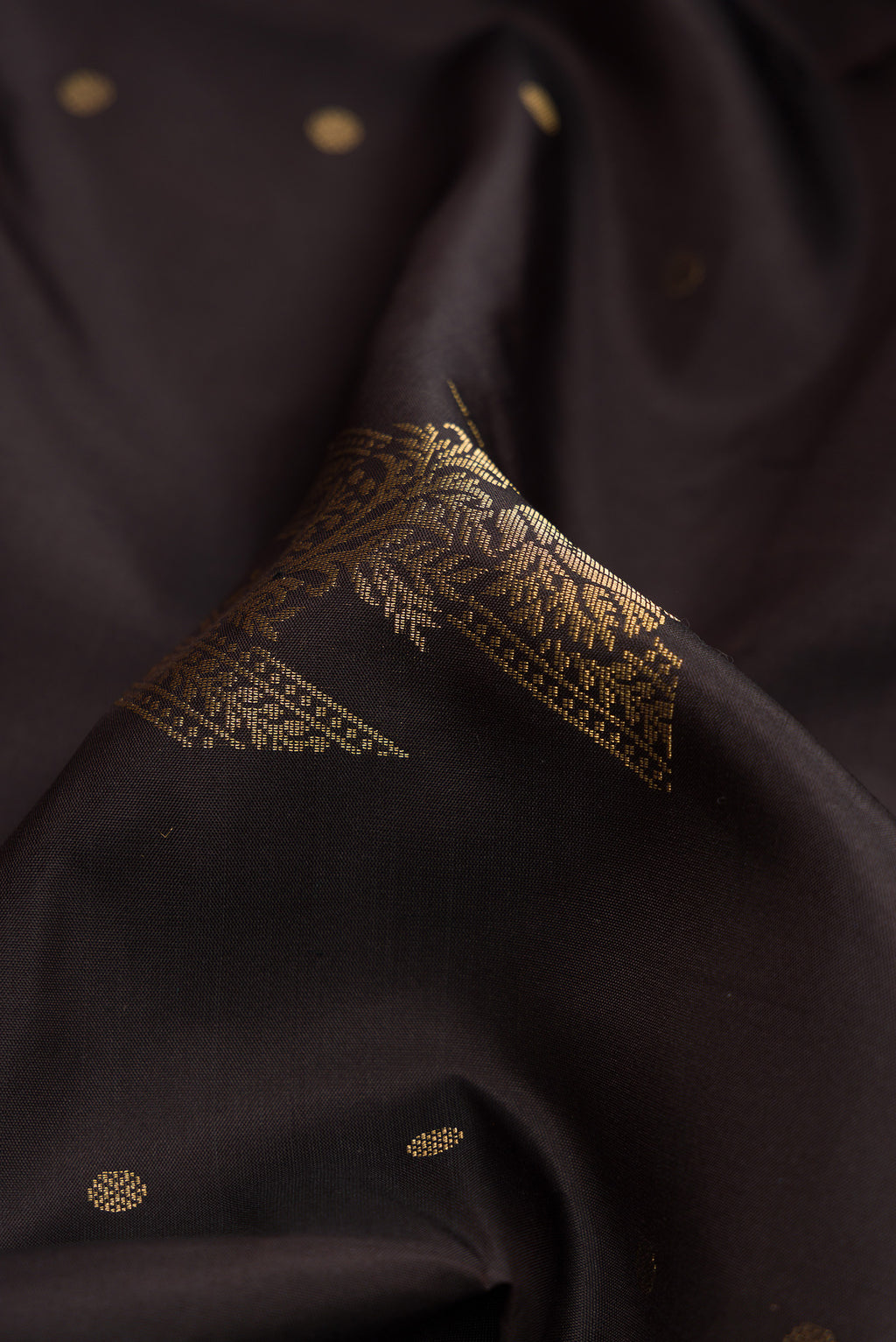 Close up of Coffee Brown Dual Tone Soft Silk Saree with Zari Butta on the body and Without Border.  displaying folds