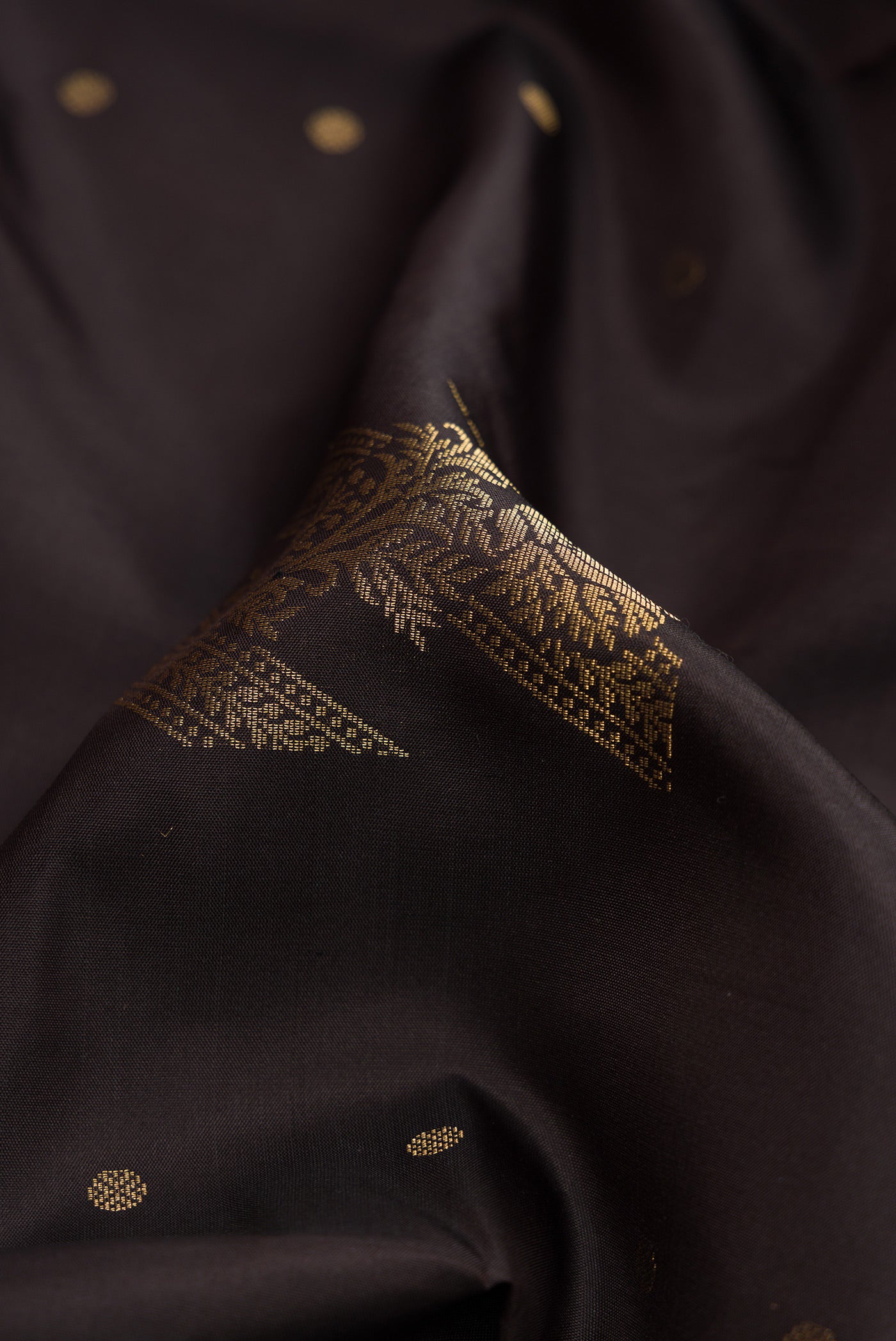 Close up of Coffee Brown Dual Tone Soft Silk Saree with Zari Butta on the body and Without Border.  displaying folds