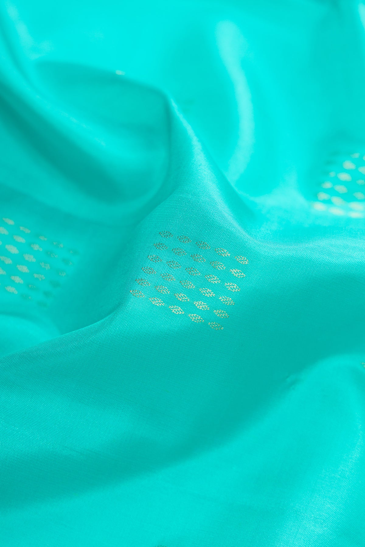 Close up of Sea Green Dual Tone Soft Silk Saree with Zari Butta on the body and Zari Border.  displaying folds