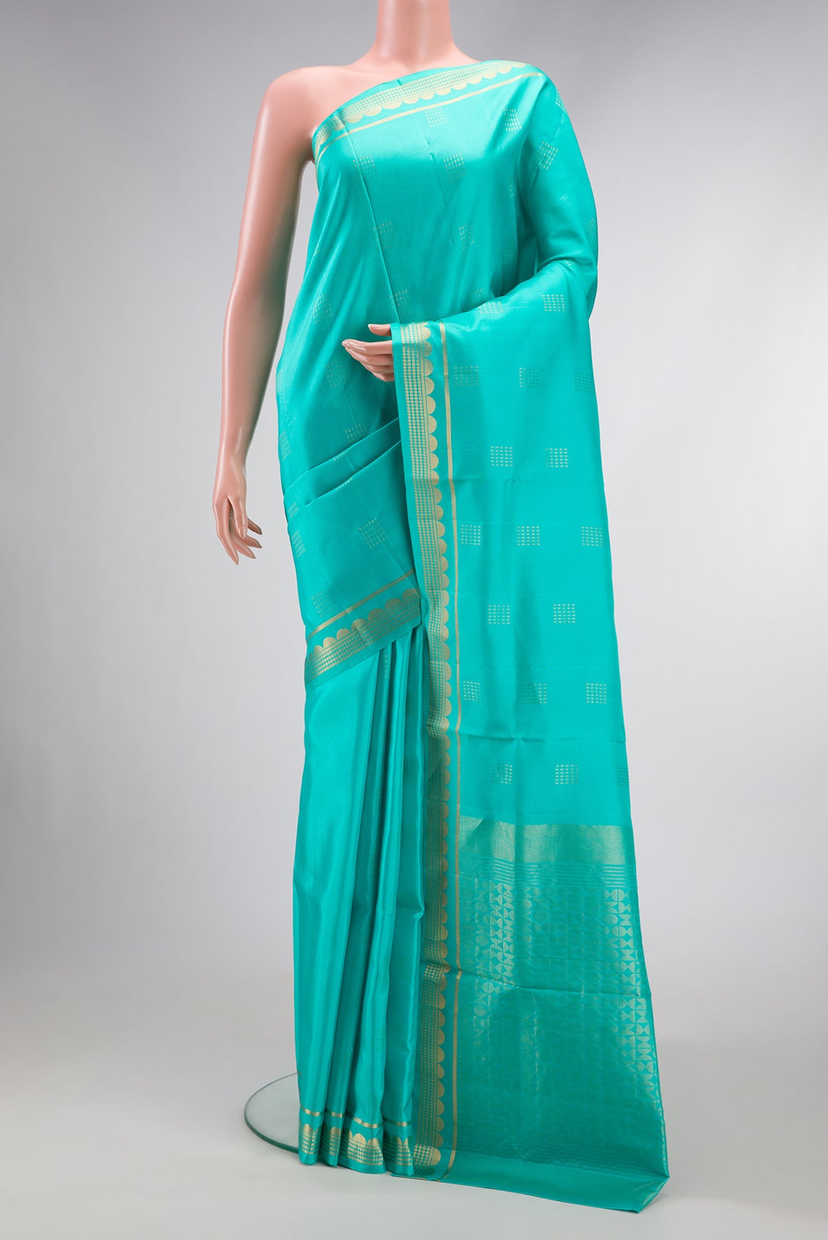 Sea Green Dual Tone Soft Silk Saree with Zari Butta on the body and Zari Border.  displayed on a mannequin