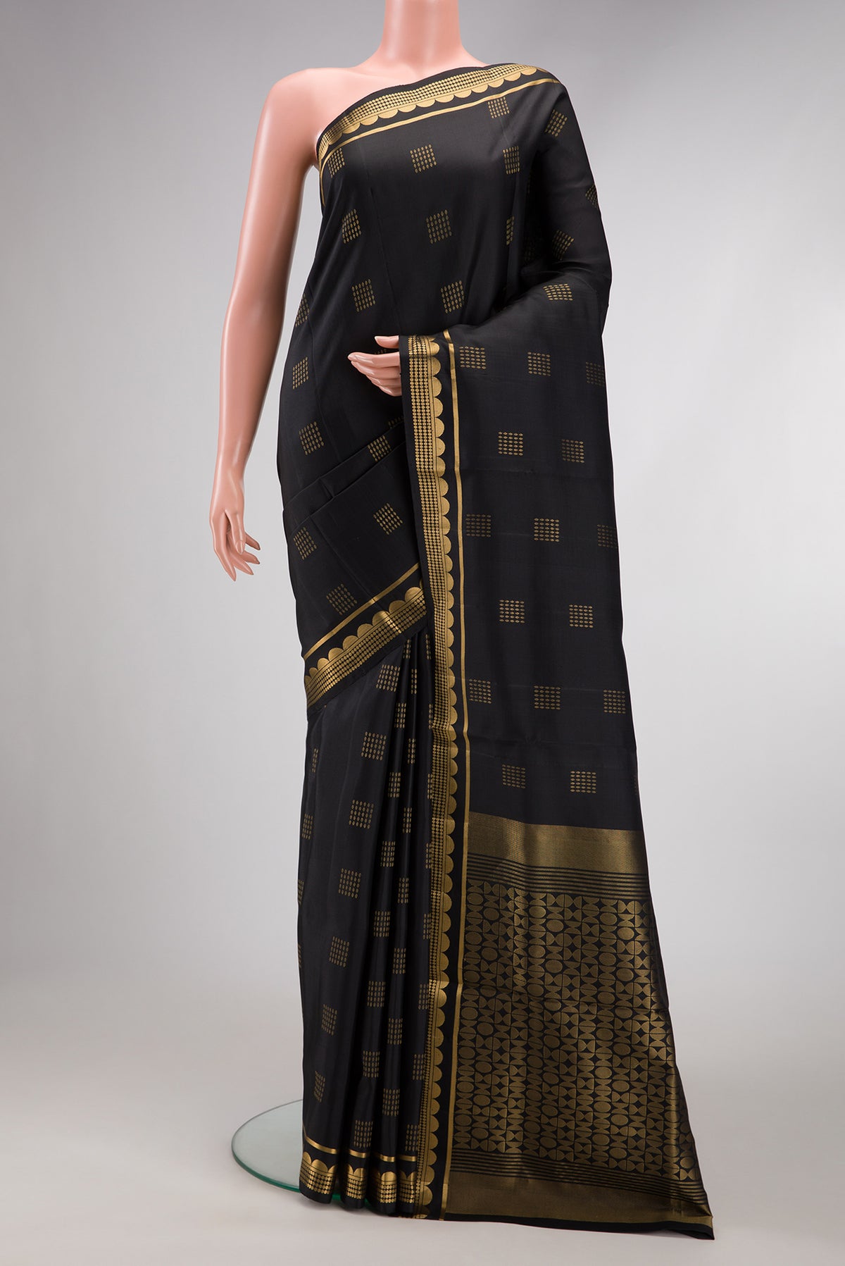 Black Dual Tone Soft Silk Saree with Zari Butta on the body and Fancy Border.  displayed on a mannequin