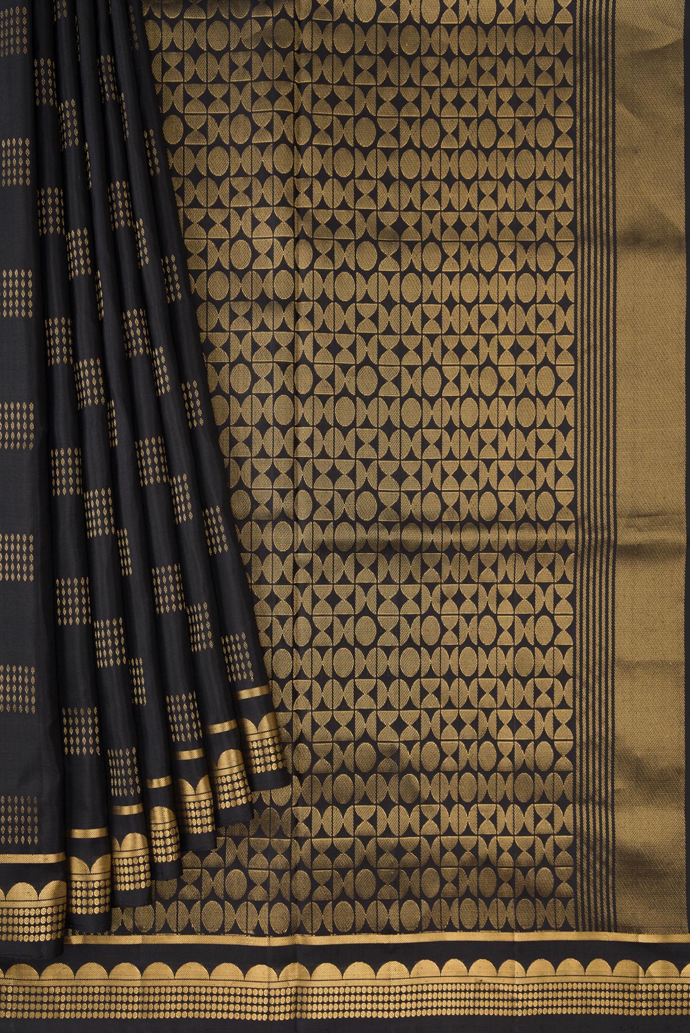 Pleats and pallu of Black Dual Tone Soft Silk Saree with Zari Butta on the body and Fancy Border. 