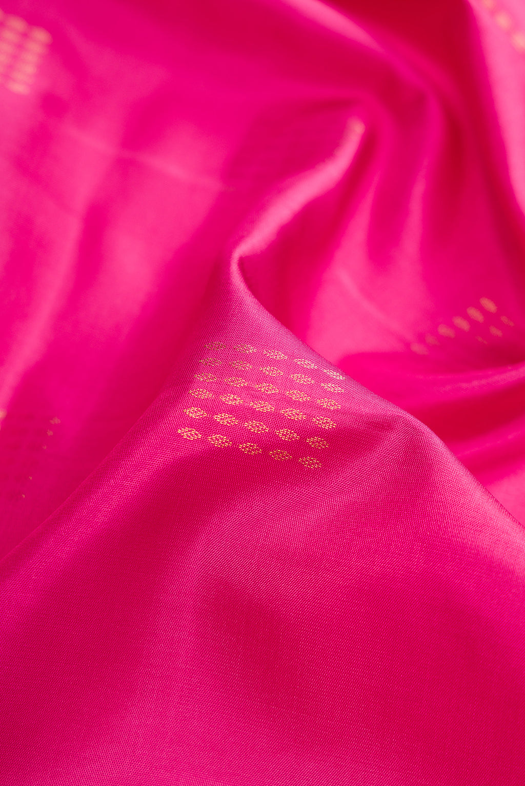 Close up of Pink Dual Tone Soft Silk Saree with Zari Butta on the body and Fancy Border.  displaying folds