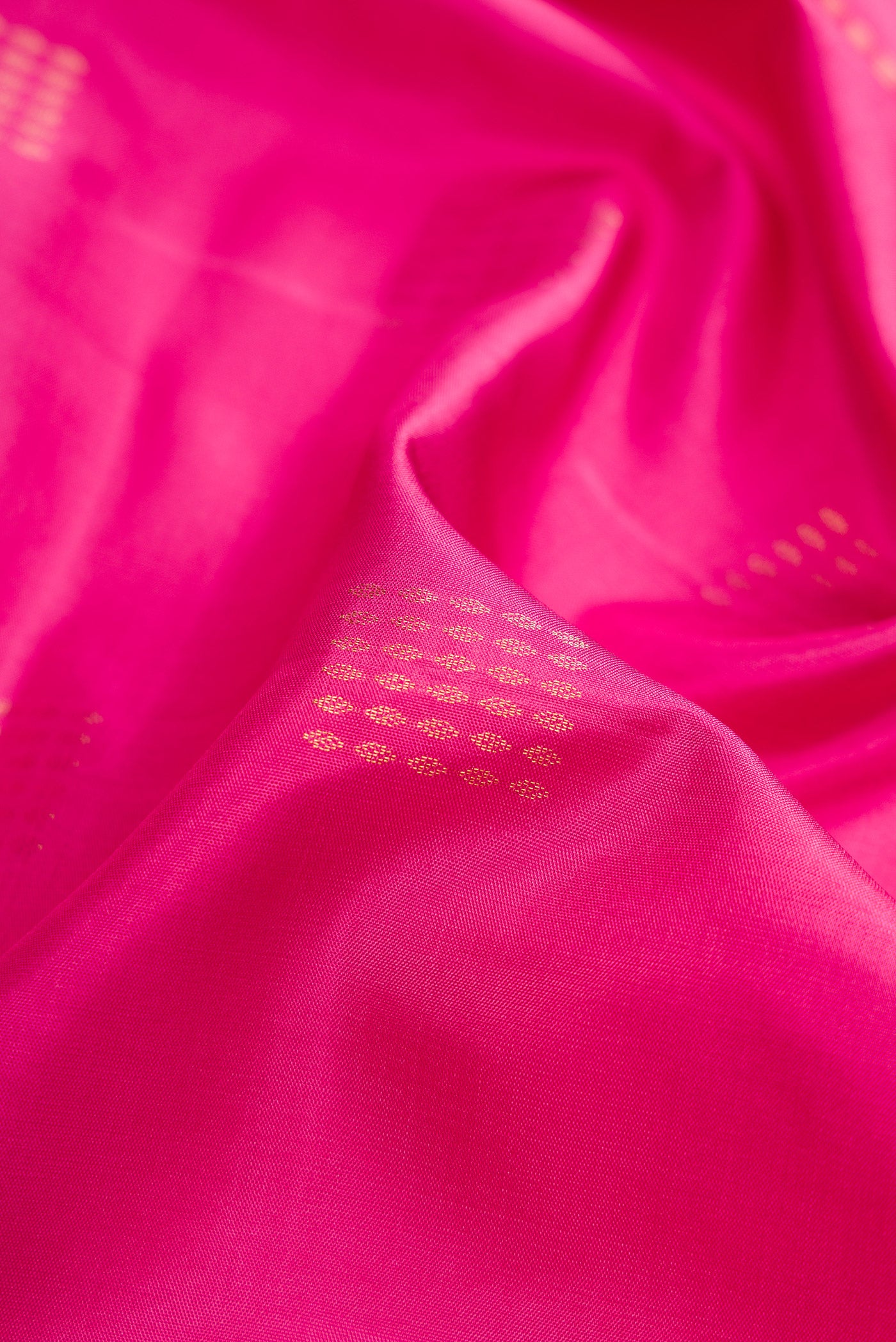 Close up of Pink Dual Tone Soft Silk Saree with Zari Butta on the body and Fancy Border.  displaying folds