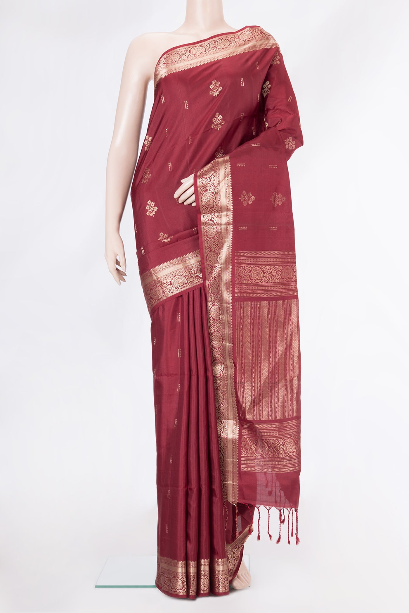 Maroon Soft Silk Saree with Zari Butta on the body and Zari Border.  displayed on a mannequin