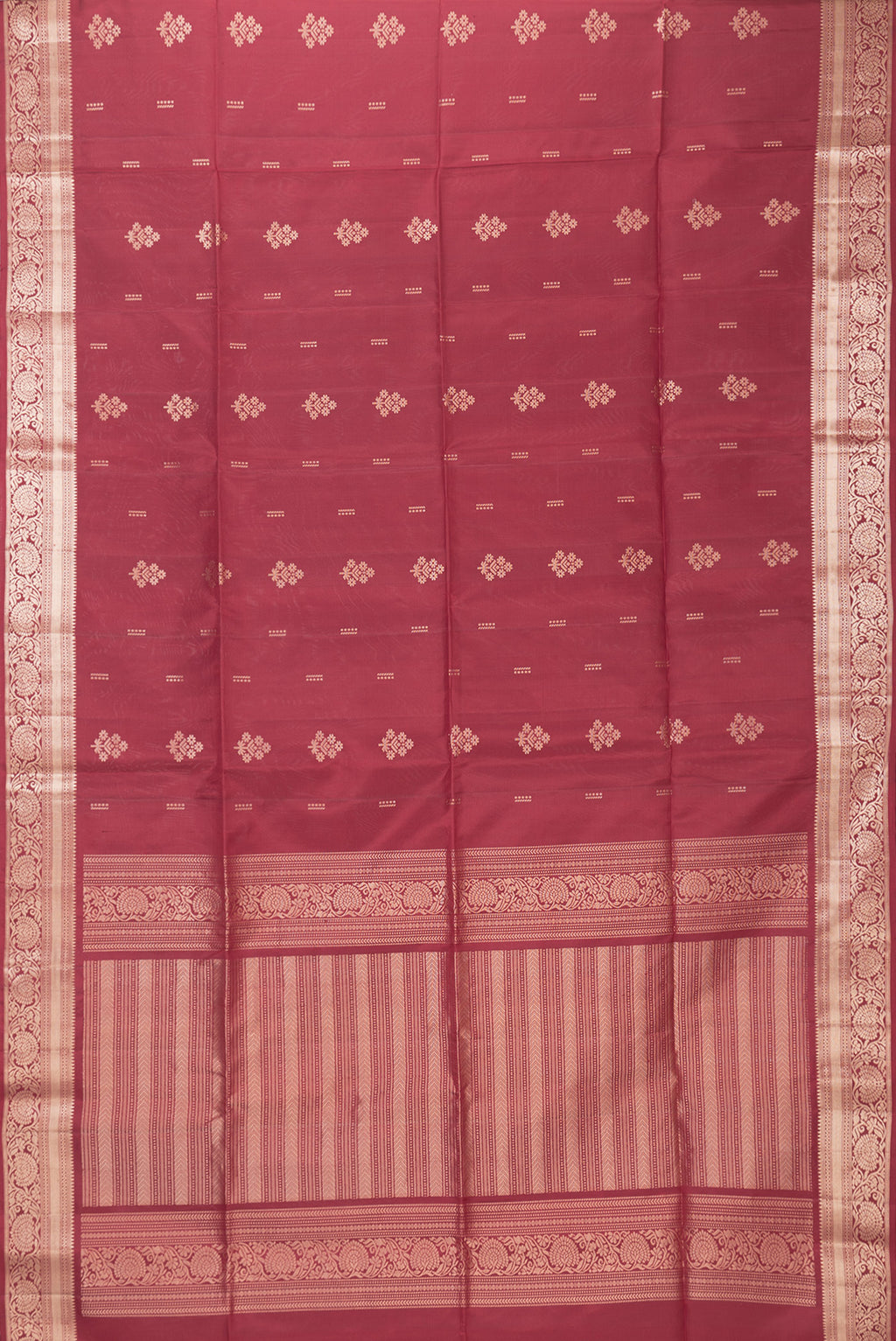 Flat view of Maroon Soft Silk Saree with Zari Butta on the body and Zari Border. 