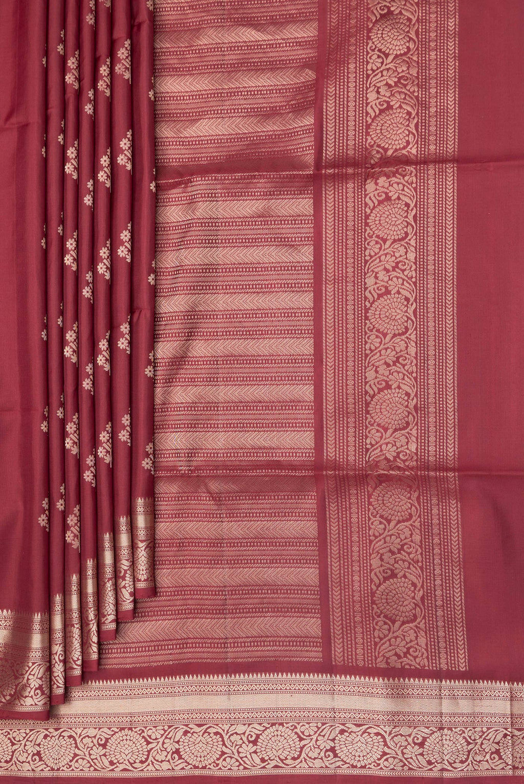 Pleats and pallu of Maroon Soft Silk Saree with Zari Butta on the body and Zari Border. 