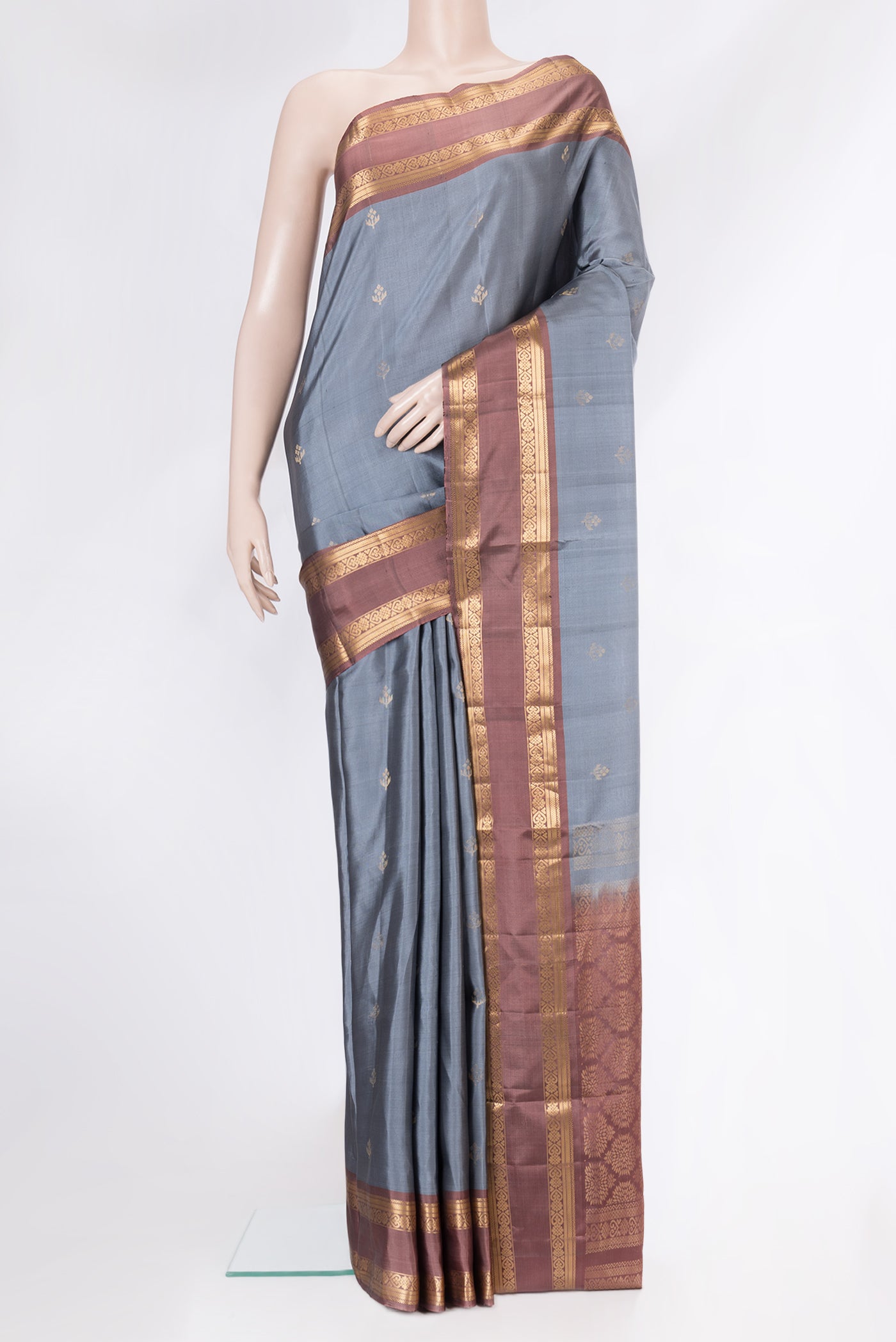 Grey Soft Silk Saree with Zari Butta on the body and Zari Border.  displayed on a mannequin