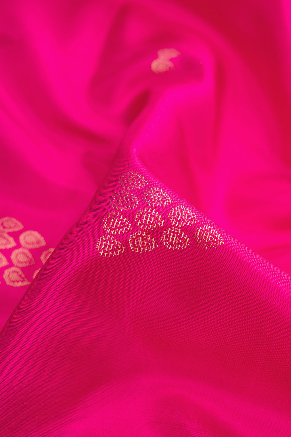 Close up of Pink Dual Tone Soft Silk Saree with Zari Butta on the body and Zari Border.  displaying folds