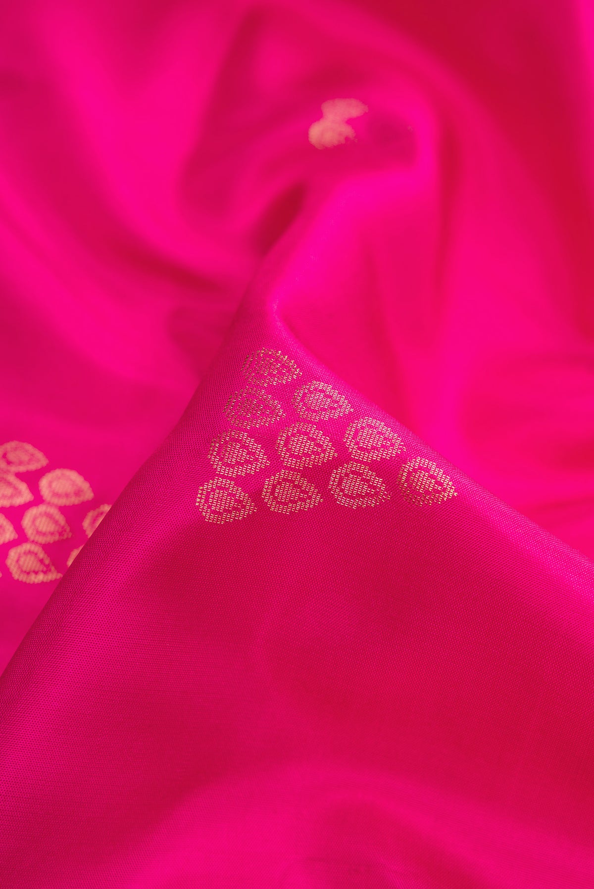 Close up of Pink Dual Tone Soft Silk Saree with Zari Butta on the body and Zari Border.  displaying folds