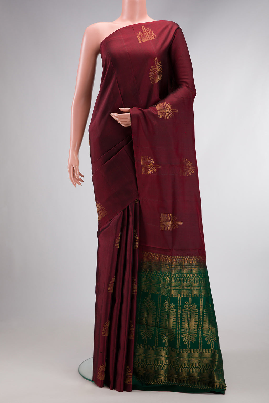 Maroon Dual Tone Soft Silk Saree with Zari Butta on the body and Without Border.  displayed on a mannequin