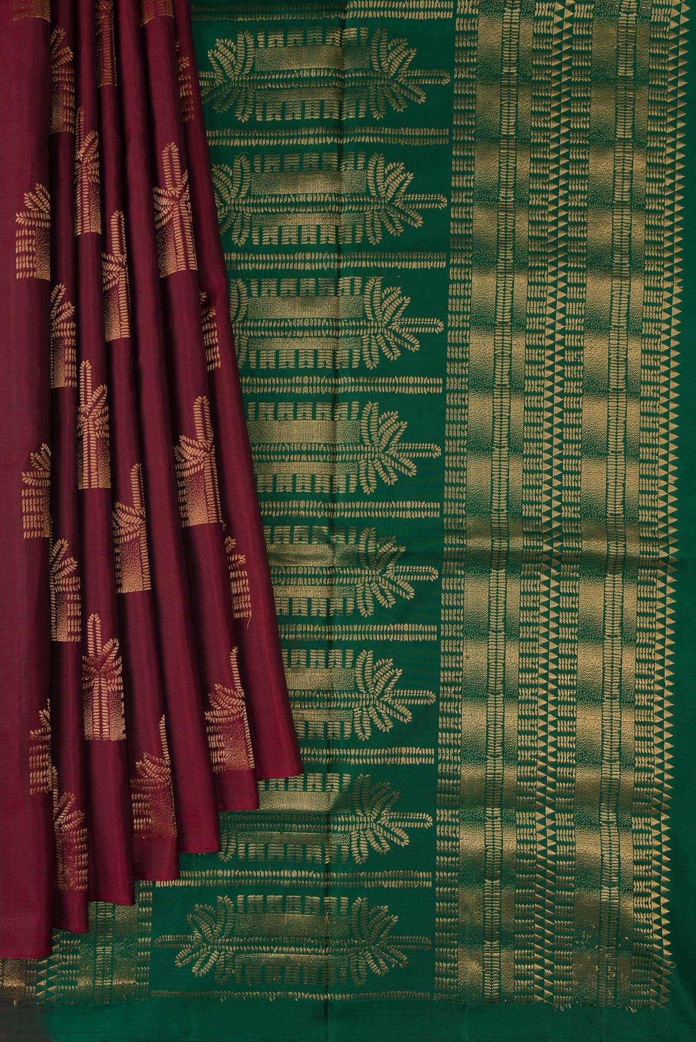 Pleats and pallu of Maroon Dual Tone Soft Silk Saree with Zari Butta on the body and Without Border. 