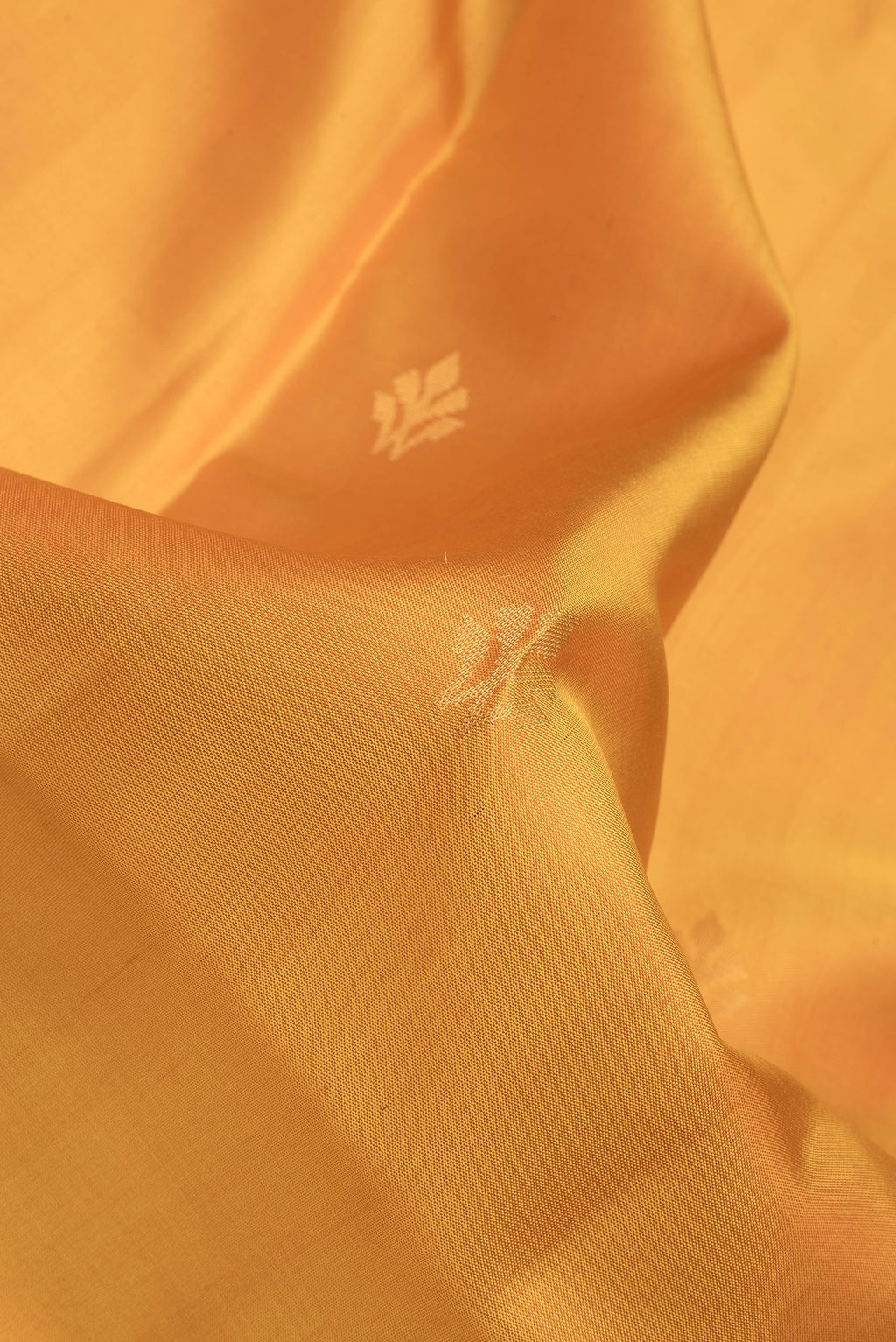Close up of Yellow Soft Silk Saree with Zari Butta on the body and Zari Border.  displaying folds