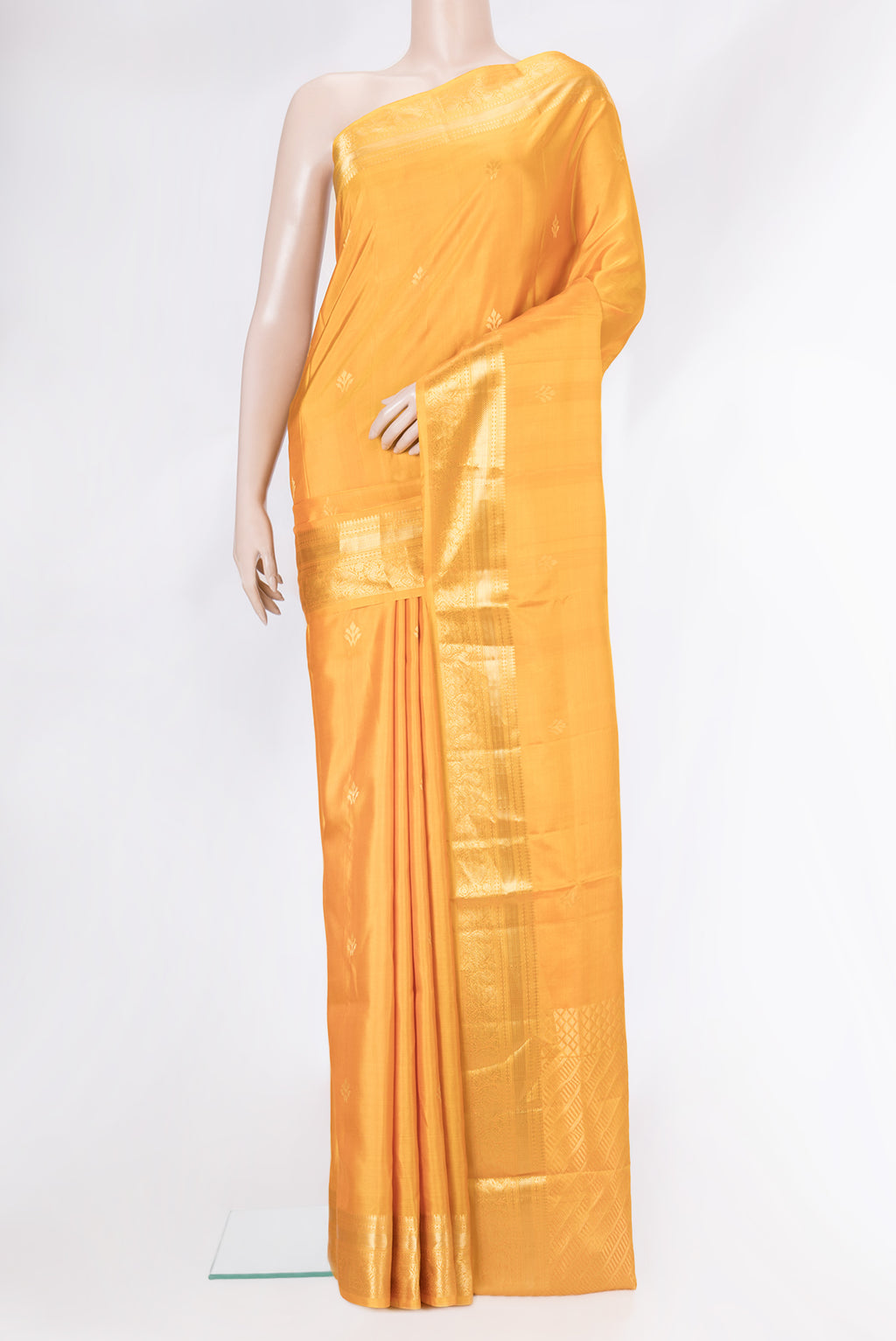 Yellow Soft Silk Saree with Zari Butta on the body and Zari Border.  displayed on a mannequin