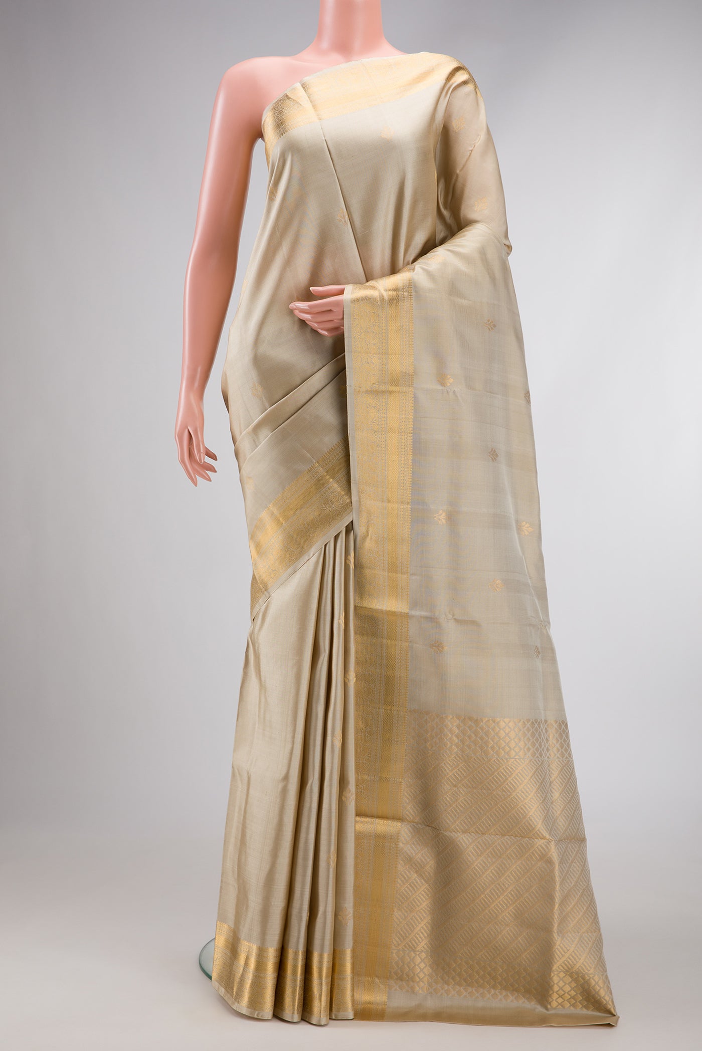 Beige Dual Tone Soft Silk Saree with Zari Butta on the body and Zari Border.  displayed on a mannequin