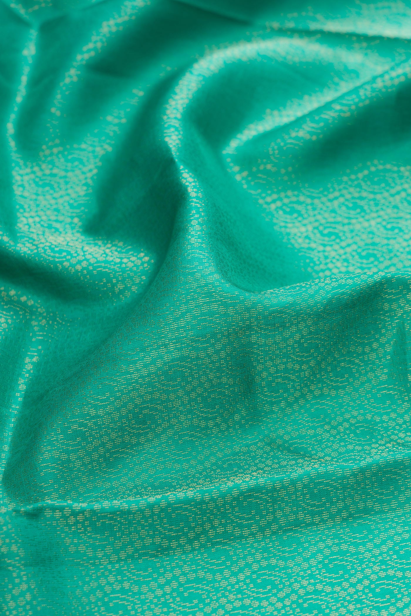 Close up of Sea Green Dual Tone Soft Silk Saree with Zari Brocade on the body and Fancy Border.  displaying folds