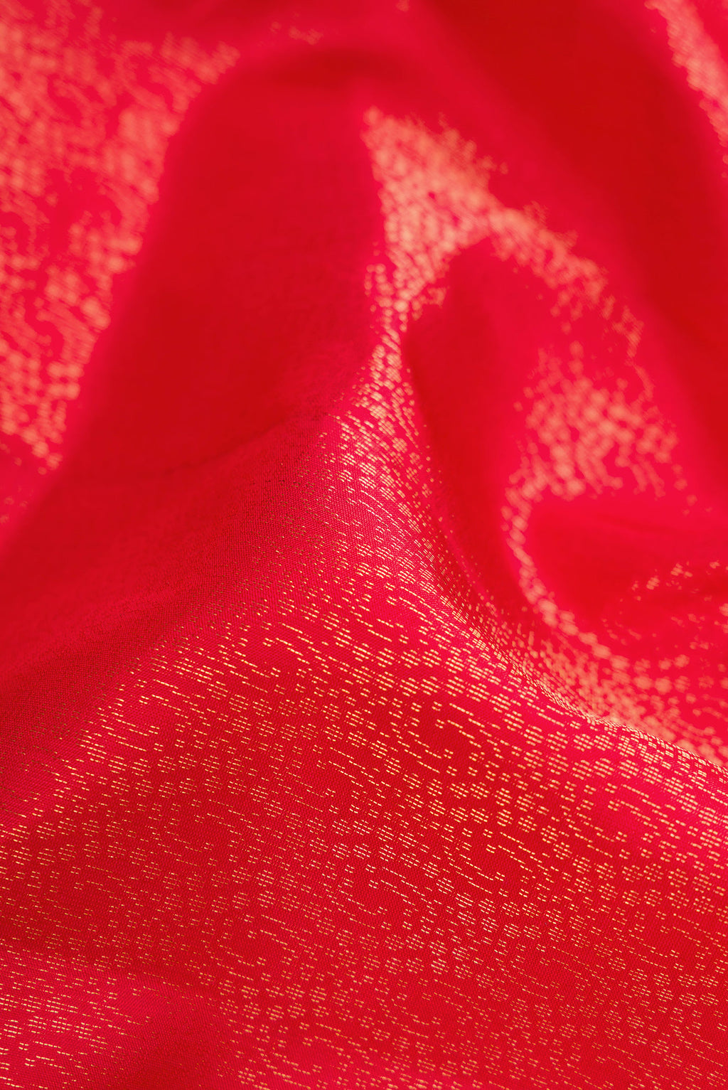 Close up of Red Dual Tone Soft Silk Saree with Zari Brocade on the body and Zari Border.  displaying folds