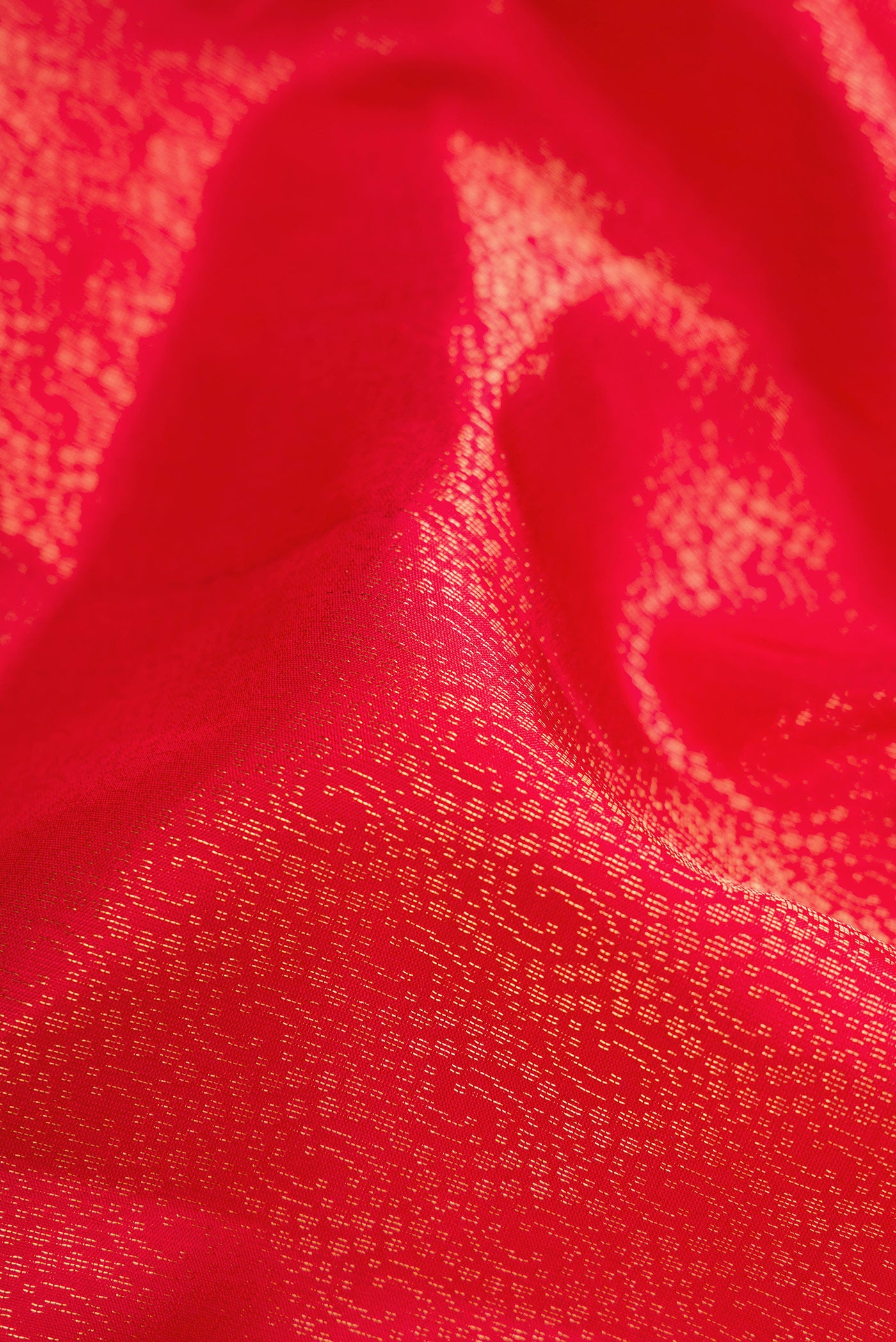 Close up of Red Dual Tone Soft Silk Saree with Zari Brocade on the body and Zari Border.  displaying folds