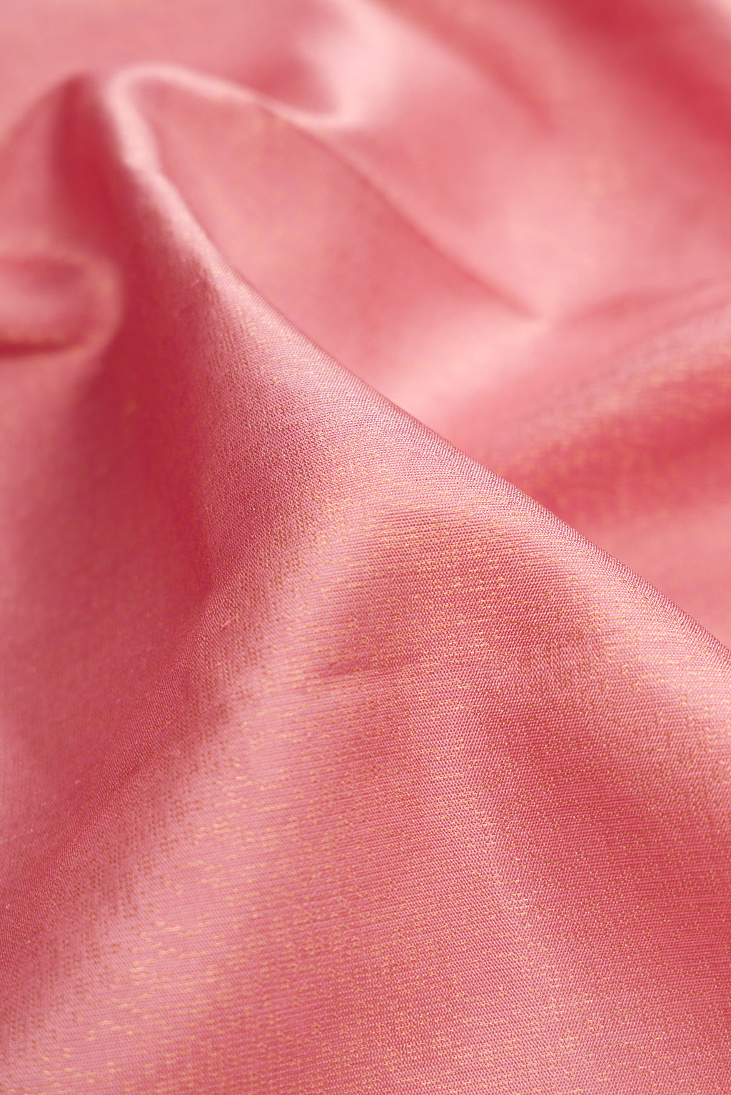 Close up of Rose Gold Dual Tone Soft Silk Saree with Zari Brocade on the body and Zari Border.  displaying folds