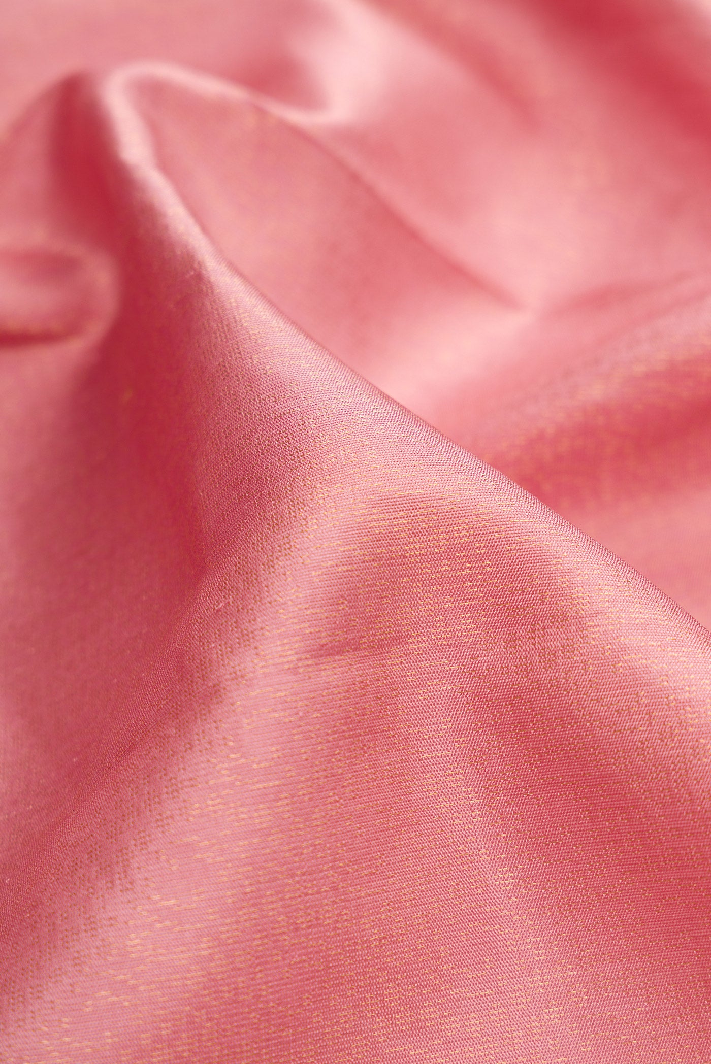 Close up of Rose Gold Dual Tone Soft Silk Saree with Zari Brocade on the body and Zari Border.  displaying folds