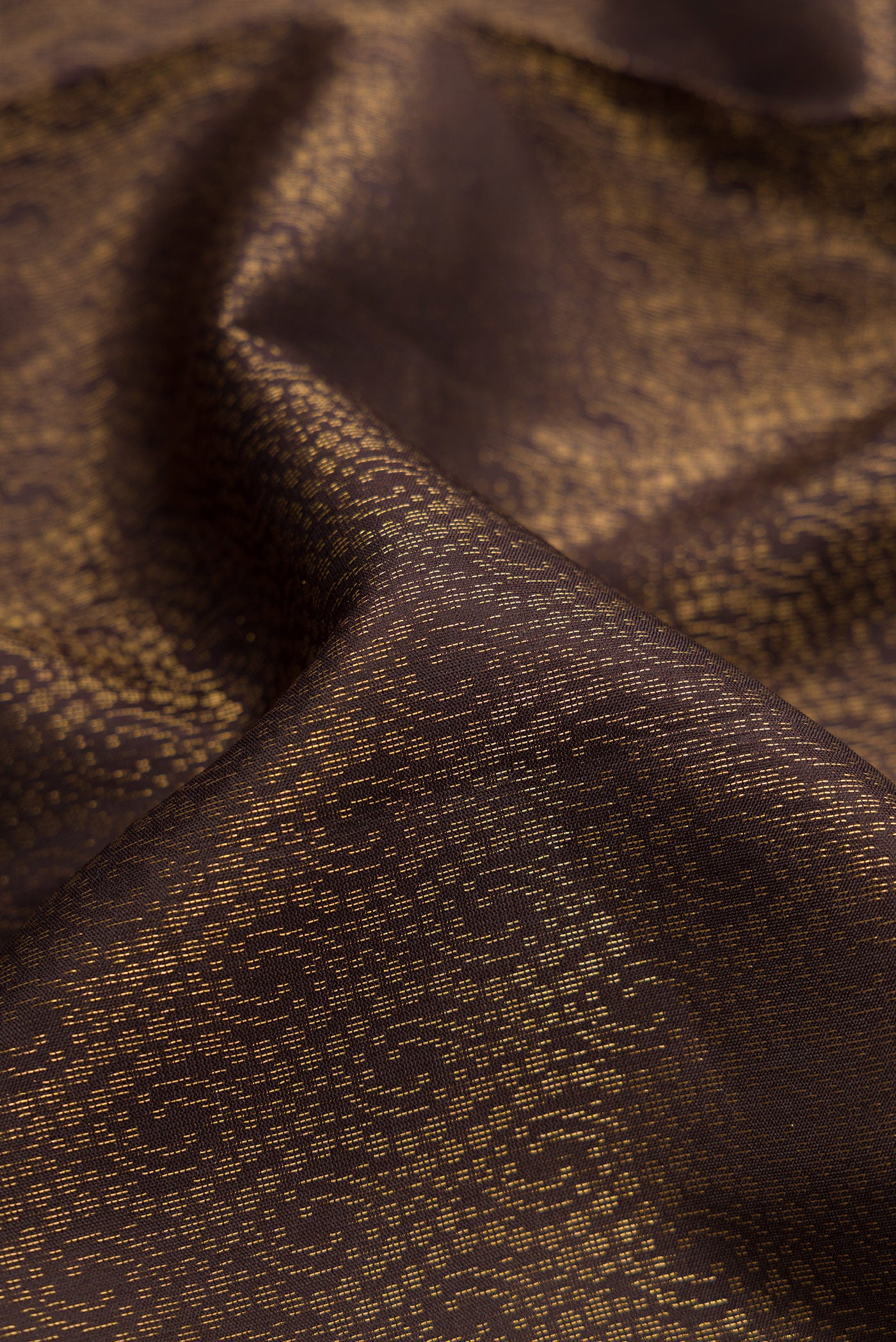 Close up of Coffee Brown Dual Tone Soft Silk Saree with Zari Brocade on the body and Zari Border.  displaying folds