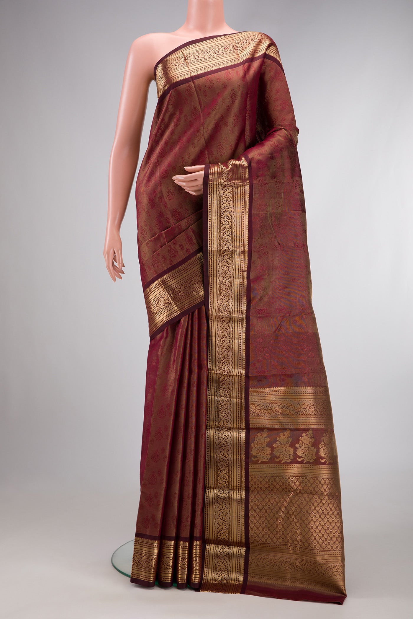Maroon Dual Tone Kanchipuram Tissue Silk Saree with Zari Brocade on the body and Zari Border.  displayed on a mannequin