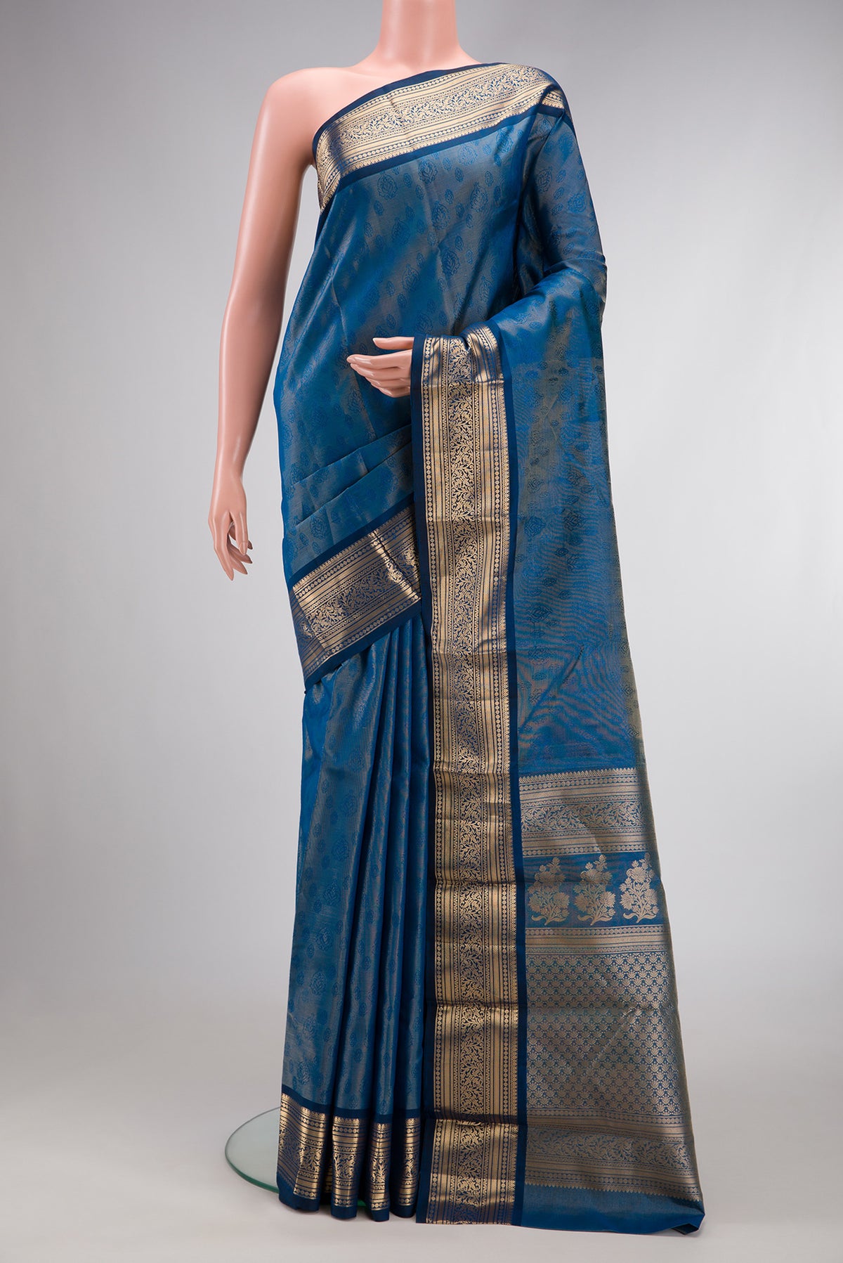 Maya Blue Dual Tone Kanchipuram Tissue Silk Saree with Zari Brocade on the body and Zari Border.  displayed on a mannequin
