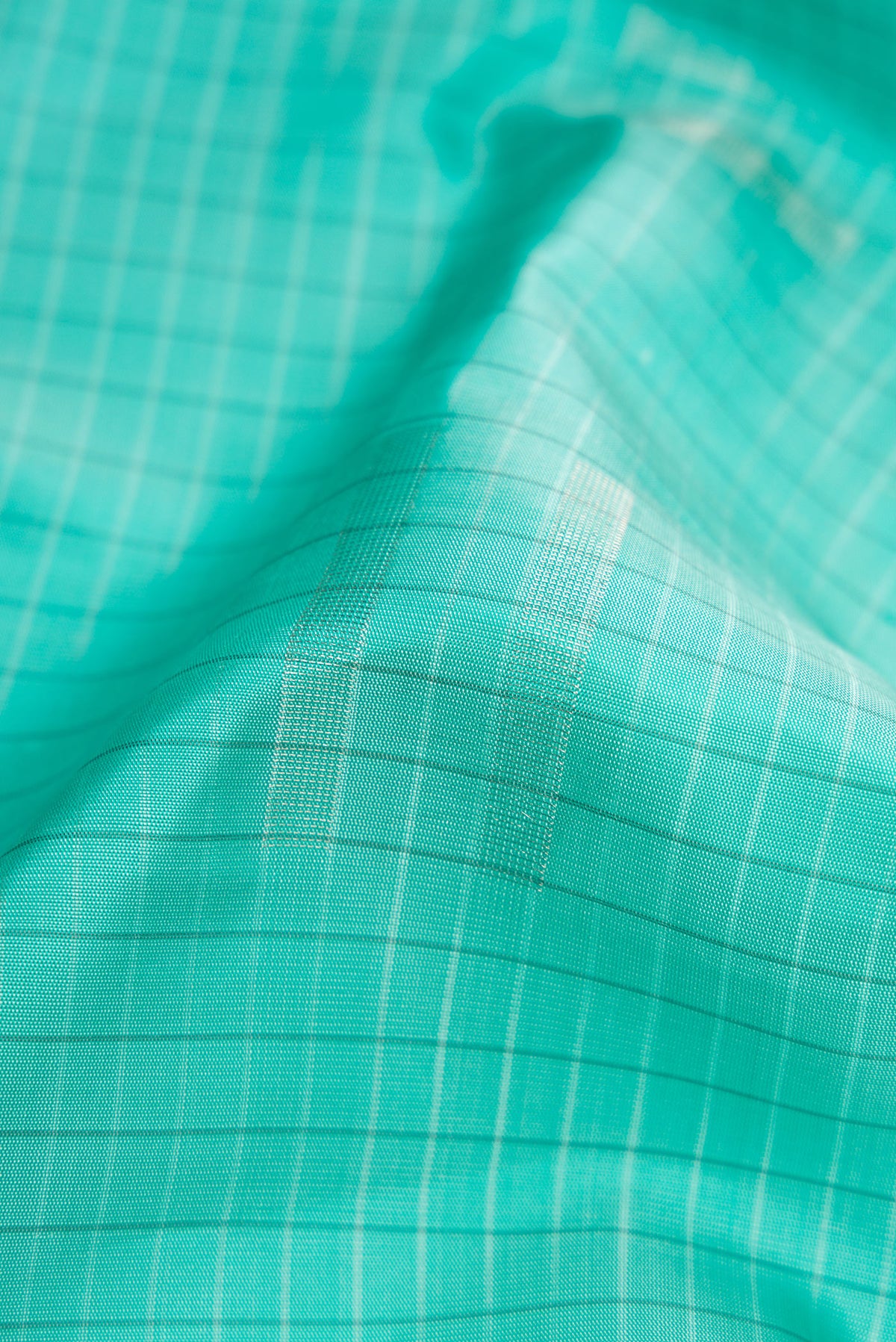 Close up of Sky Blue Dual Tone Soft Silk Saree with Stripes on the body and Without Border.  displaying folds