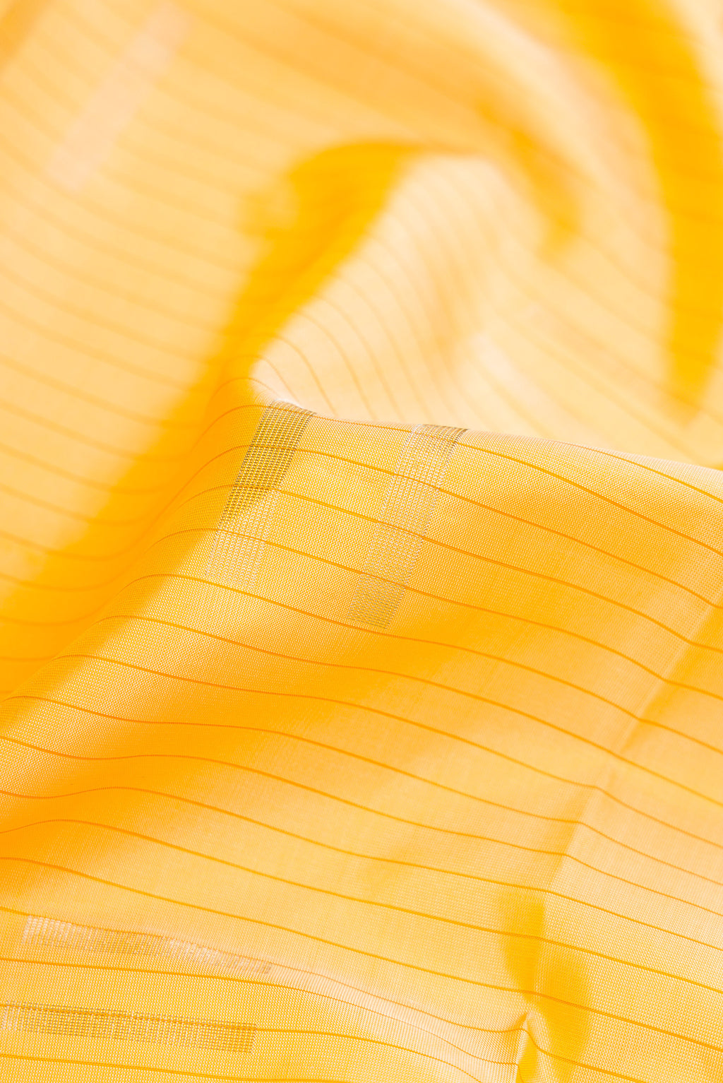 Close up of Sandal Dual Tone Soft Silk Saree with Stripes on the body and Without Border.  displaying folds