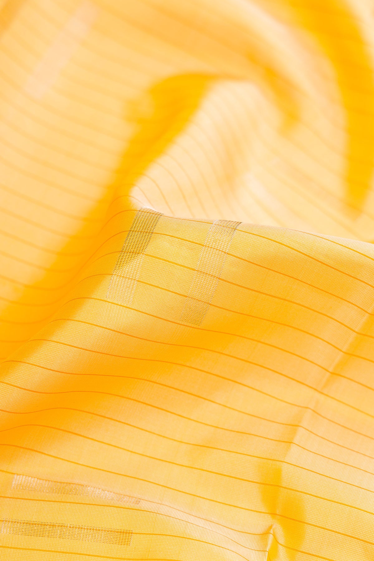 Close up of Sandal Dual Tone Soft Silk Saree with Stripes on the body and Without Border.  displaying folds