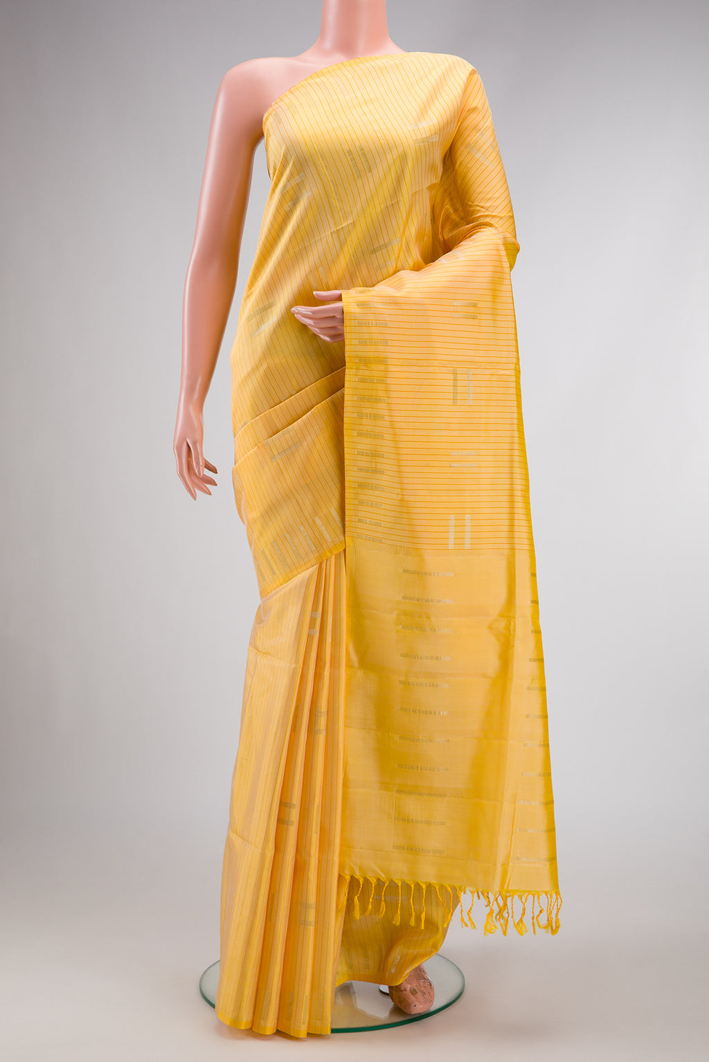 Sandal Dual Tone Soft Silk Saree with Stripes on the body and Without Border.  displayed on a mannequin