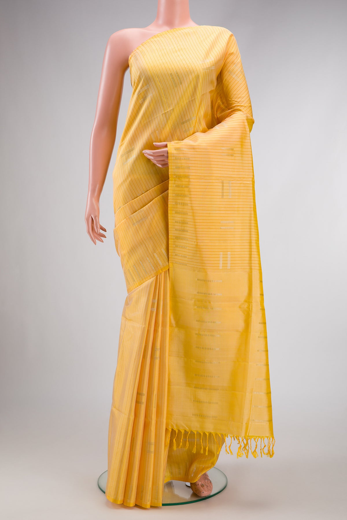 Sandal Dual Tone Soft Silk Saree with Stripes on the body and Without Border.  displayed on a mannequin