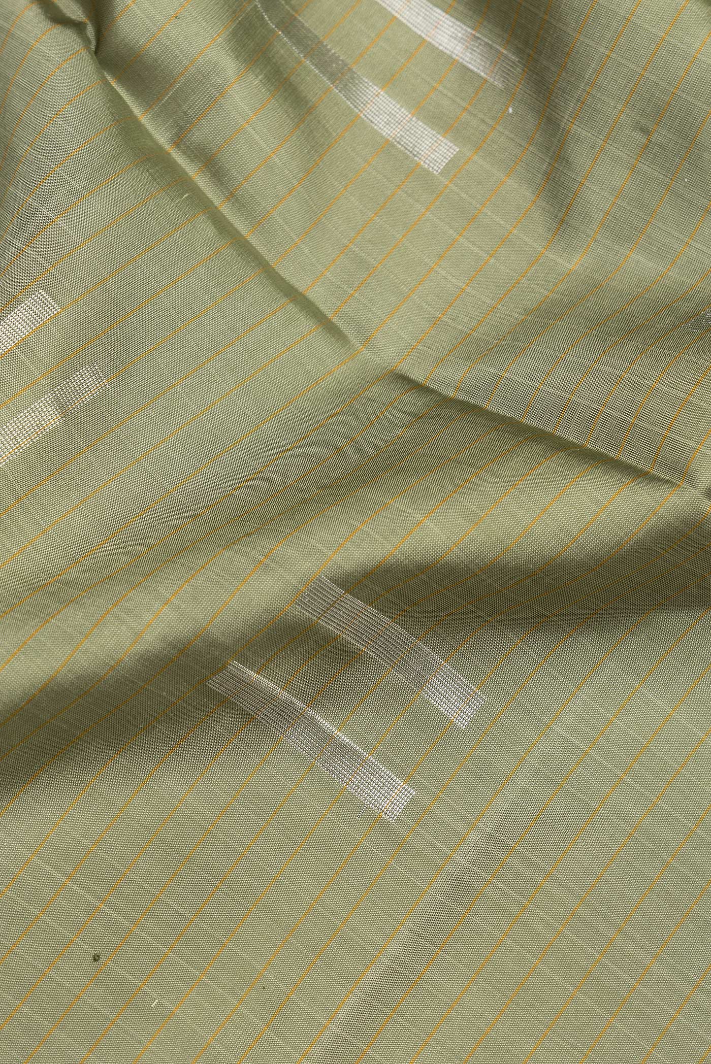 Close up of Pista Green Dual Tone Soft Silk Saree with Zari Butta on the body and Zari Border.  displaying folds