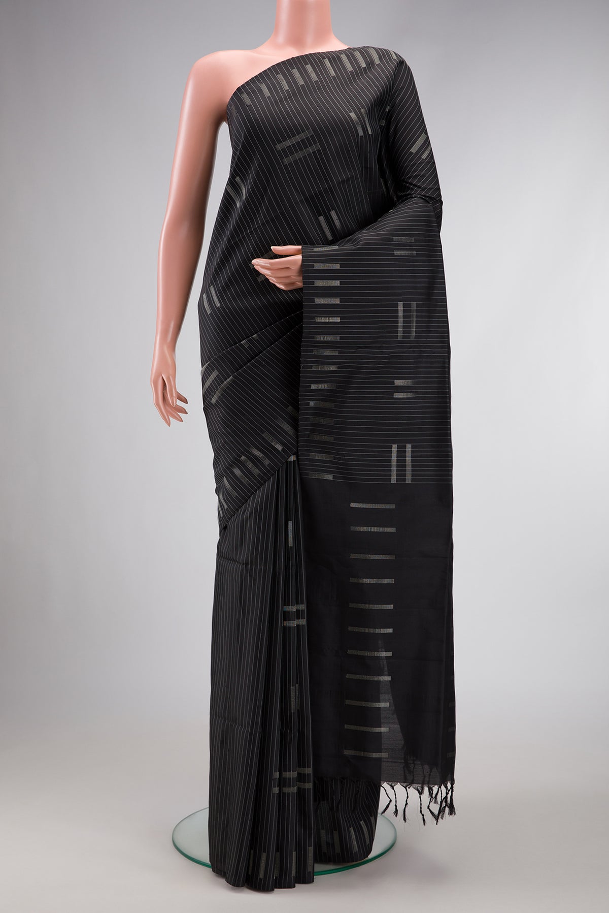 Black Dual Tone Soft Silk Saree with Stripes on the body and Zari Border.  displayed on a mannequin