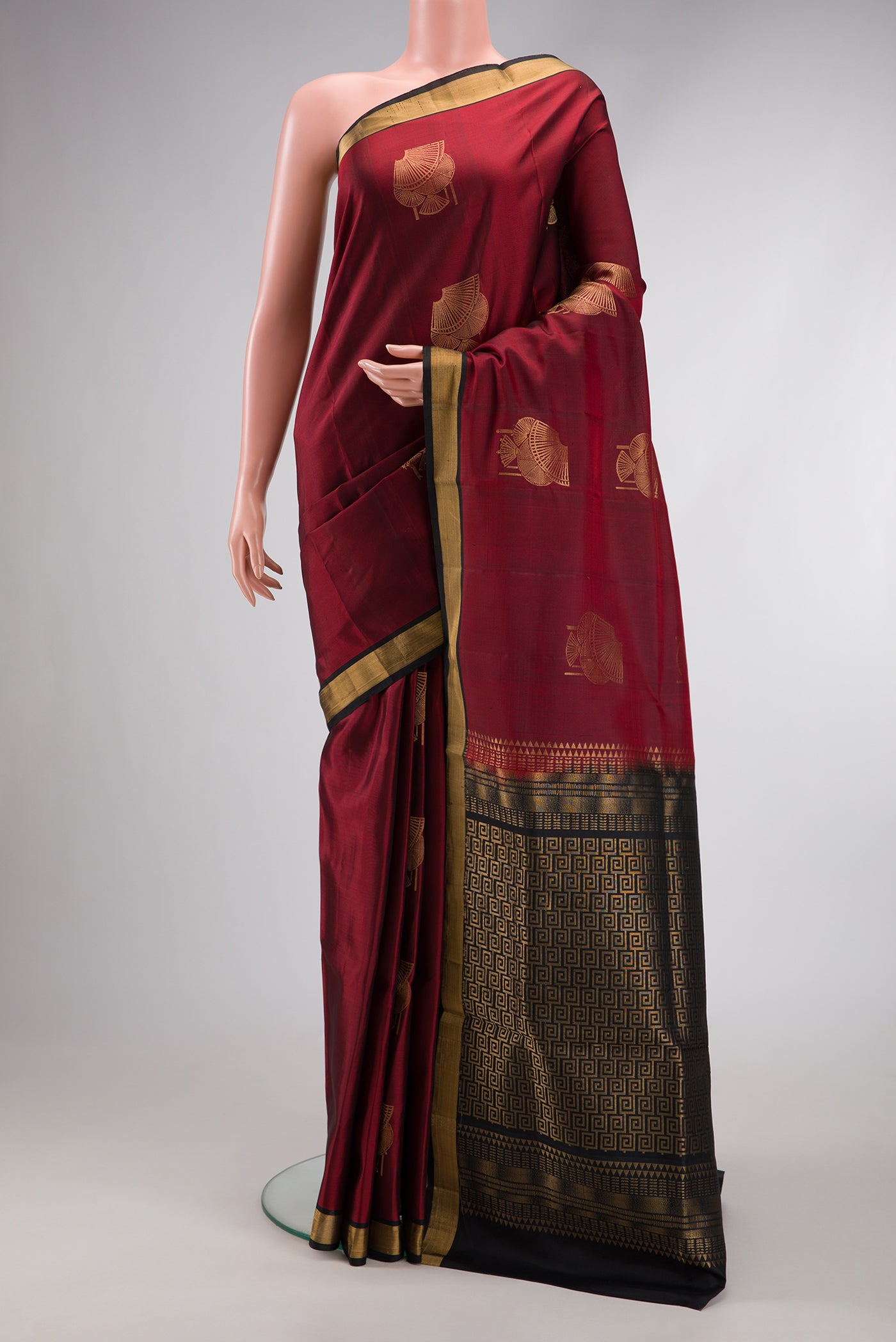 Maroon Dual Tone Soft Silk Saree with Zari Butta on the body and Zari Border.  displayed on a mannequin