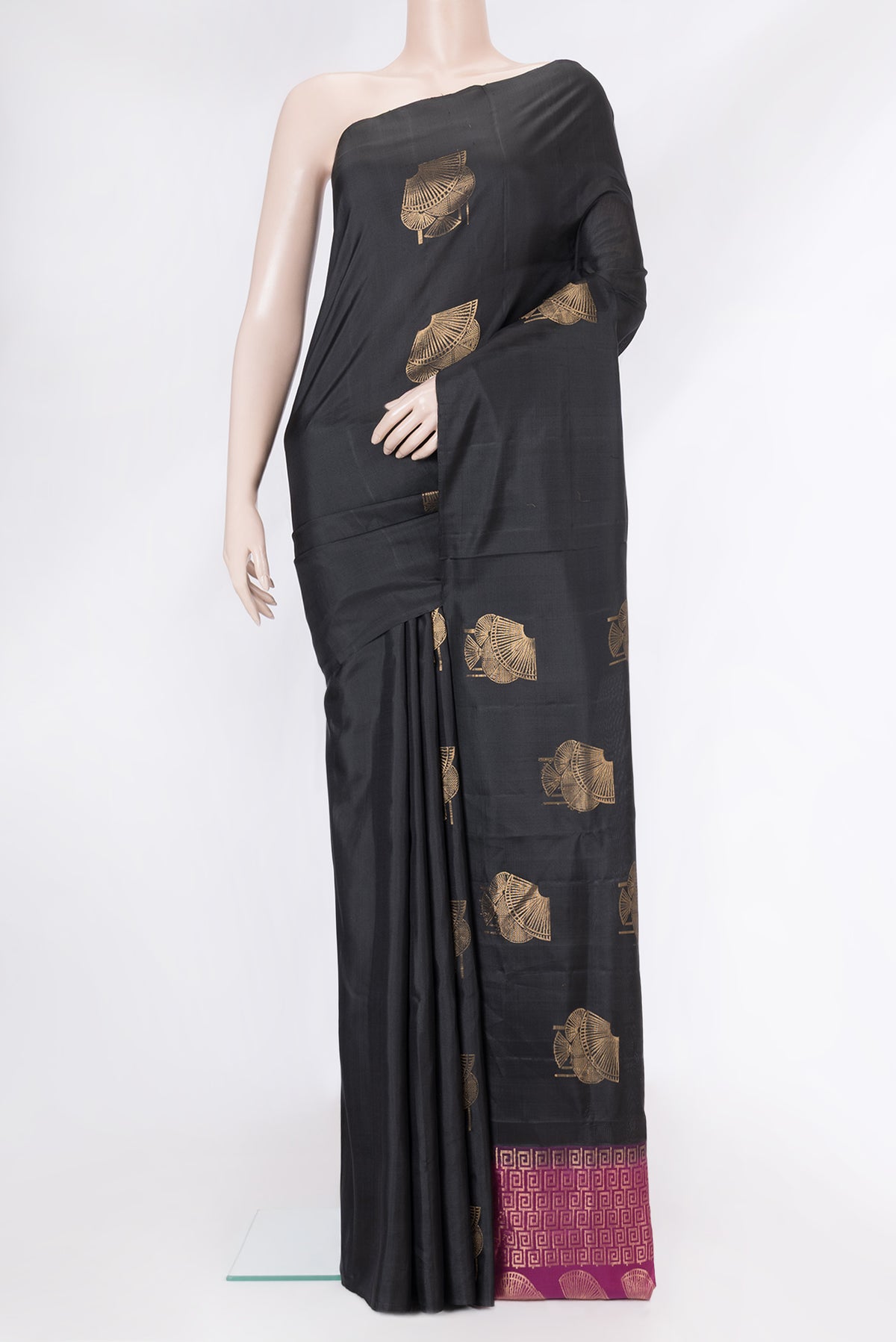 Black Soft Silk Saree with Zari Butta on the body and Without Border.  displayed on a mannequin
