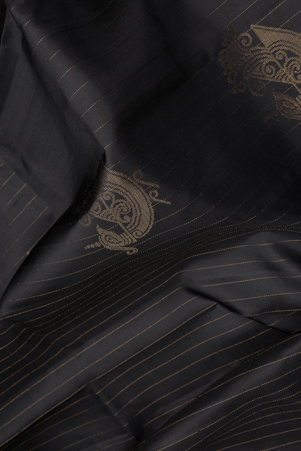 Close up of Black Soft Silk Saree with Stripes on the body and Without Border.  displaying folds