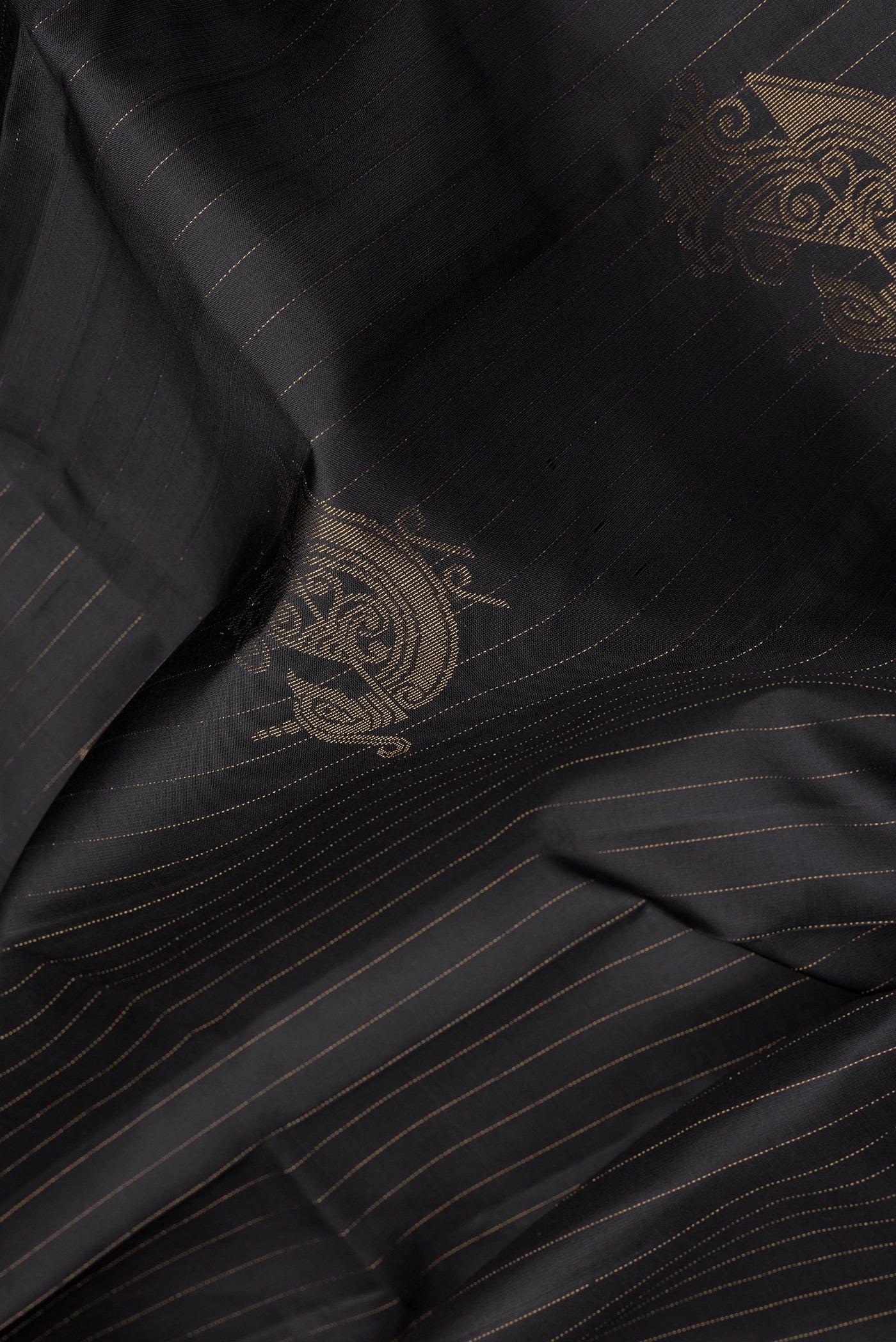 Close up of Black Soft Silk Saree with Stripes on the body and Without Border.  displaying folds