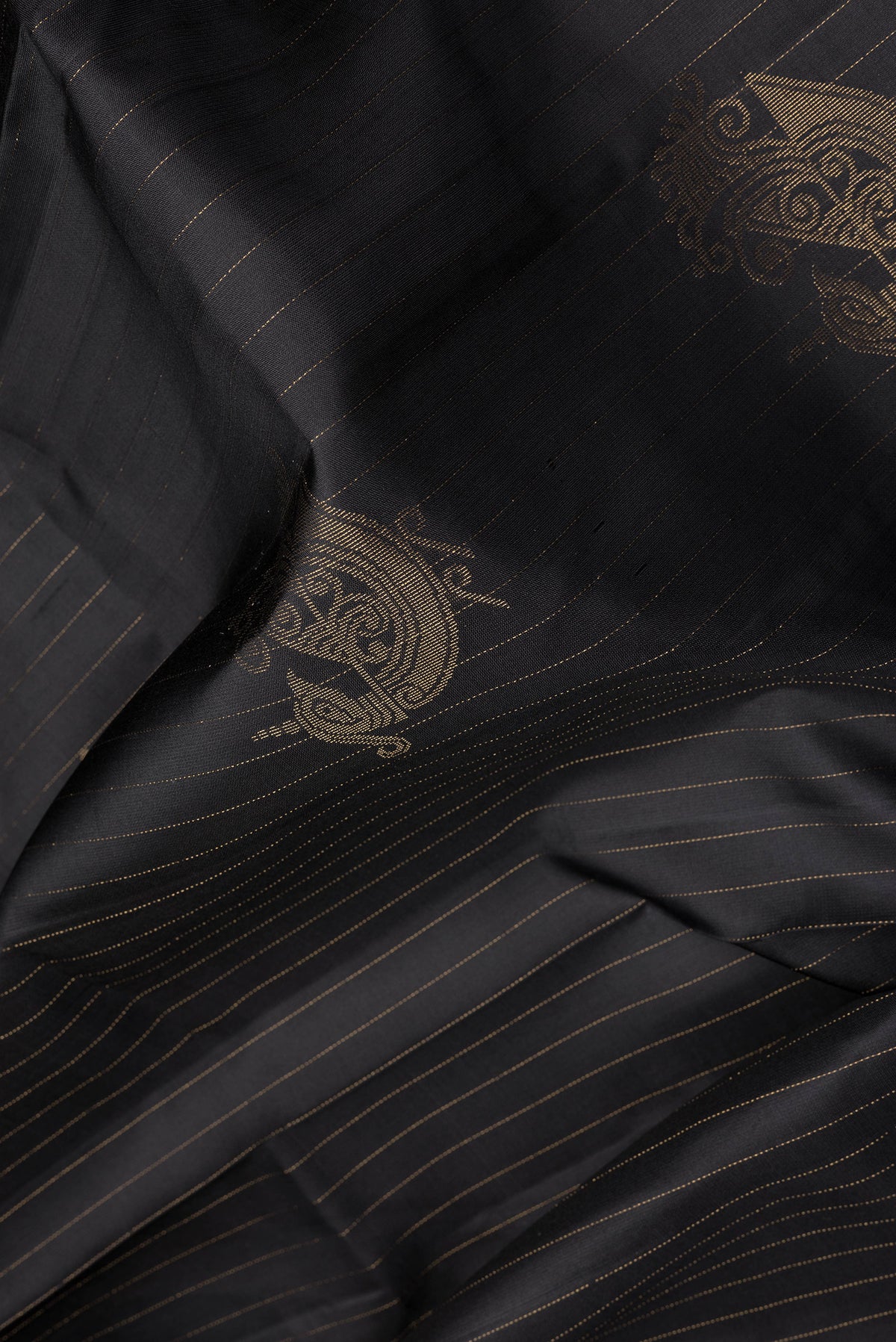 Close up of Black Soft Silk Saree with Stripes on the body and Without Border.  displaying folds