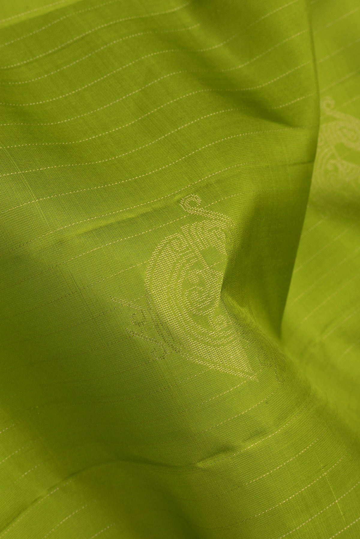 Close up of Green Soft Silk Saree with Stripes on the body and Without Border.  displaying folds