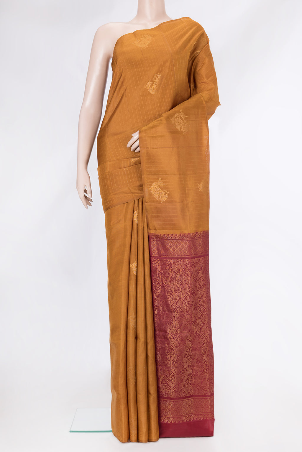 Mustard Soft Silk Saree with Stripes on the body and Without Border.  displayed on a mannequin