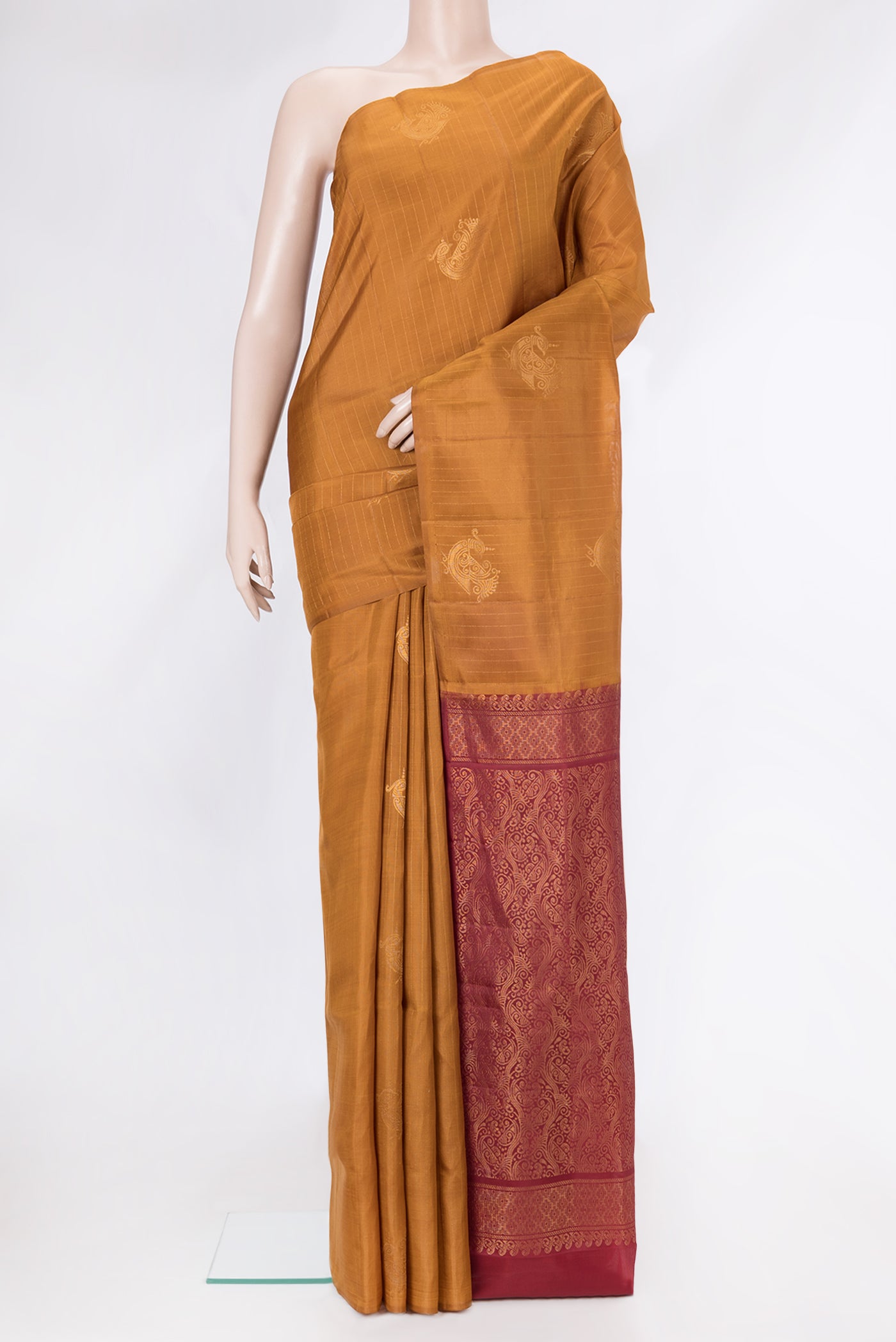 Mustard Soft Silk Saree with Stripes on the body and Without Border.  displayed on a mannequin