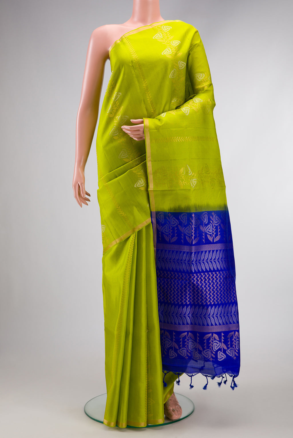 Parrot Green Dual Tone Soft Silk Saree with Zari Butta on the body and Zari Border.  displayed on a mannequin