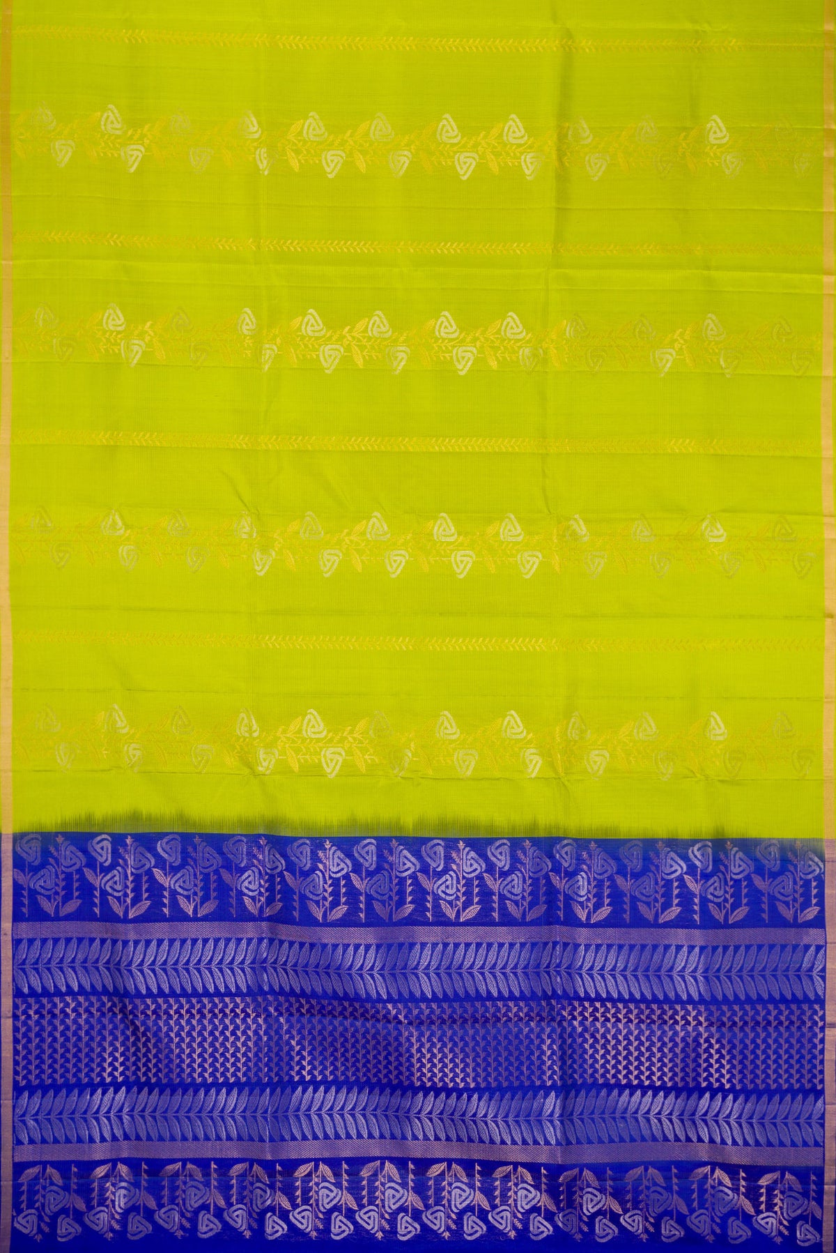 Flat view of Parrot Green Dual Tone Soft Silk Saree with Zari Butta on the body and Zari Border. 