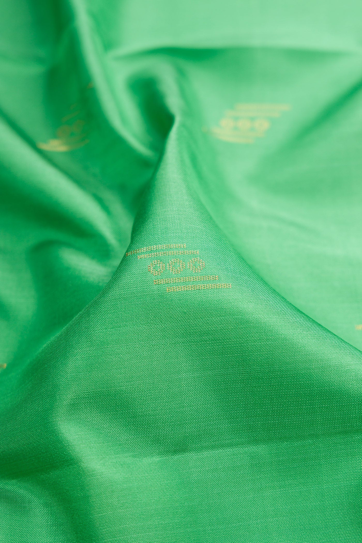 Close up of Pista Green Dual Tone Soft Silk Saree with Zari Butta on the body and Zari Border.  displaying folds