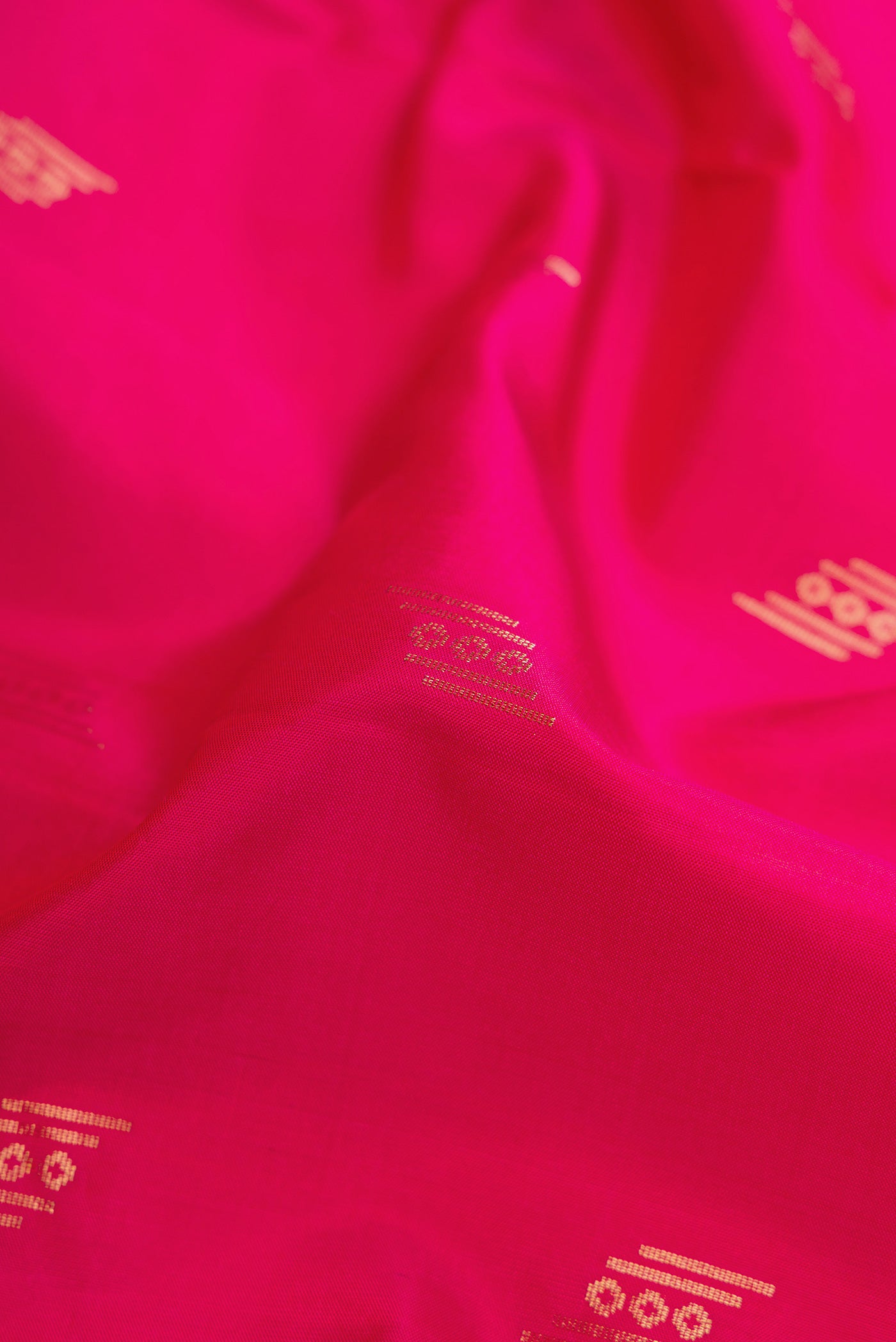 Close up of Dark Pink Dual Tone Soft Silk Saree with Zari Butta on the body and Zari Border.  displaying folds