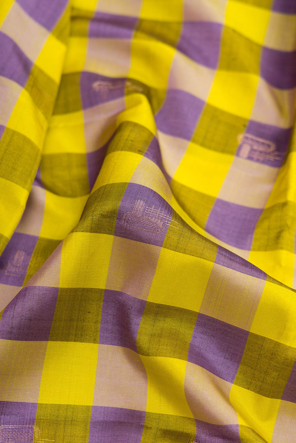 Close up of Parrot Green and Royal Blue Color Soft Silk Saree with Checked design on the body and Checks Border.  displaying folds